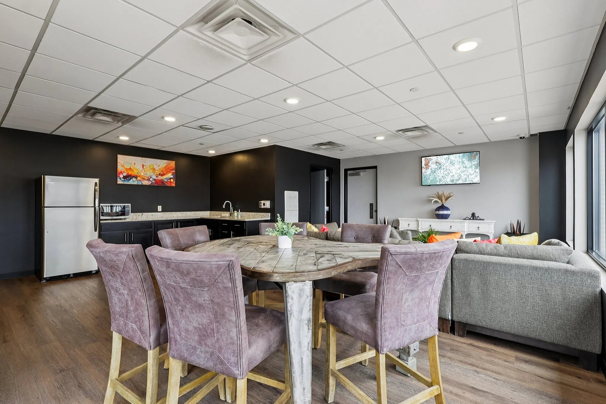 Chic apartment interior showcasing a modern open-concept living area with plush seating, stylish dining set, and sleek kitchen design.