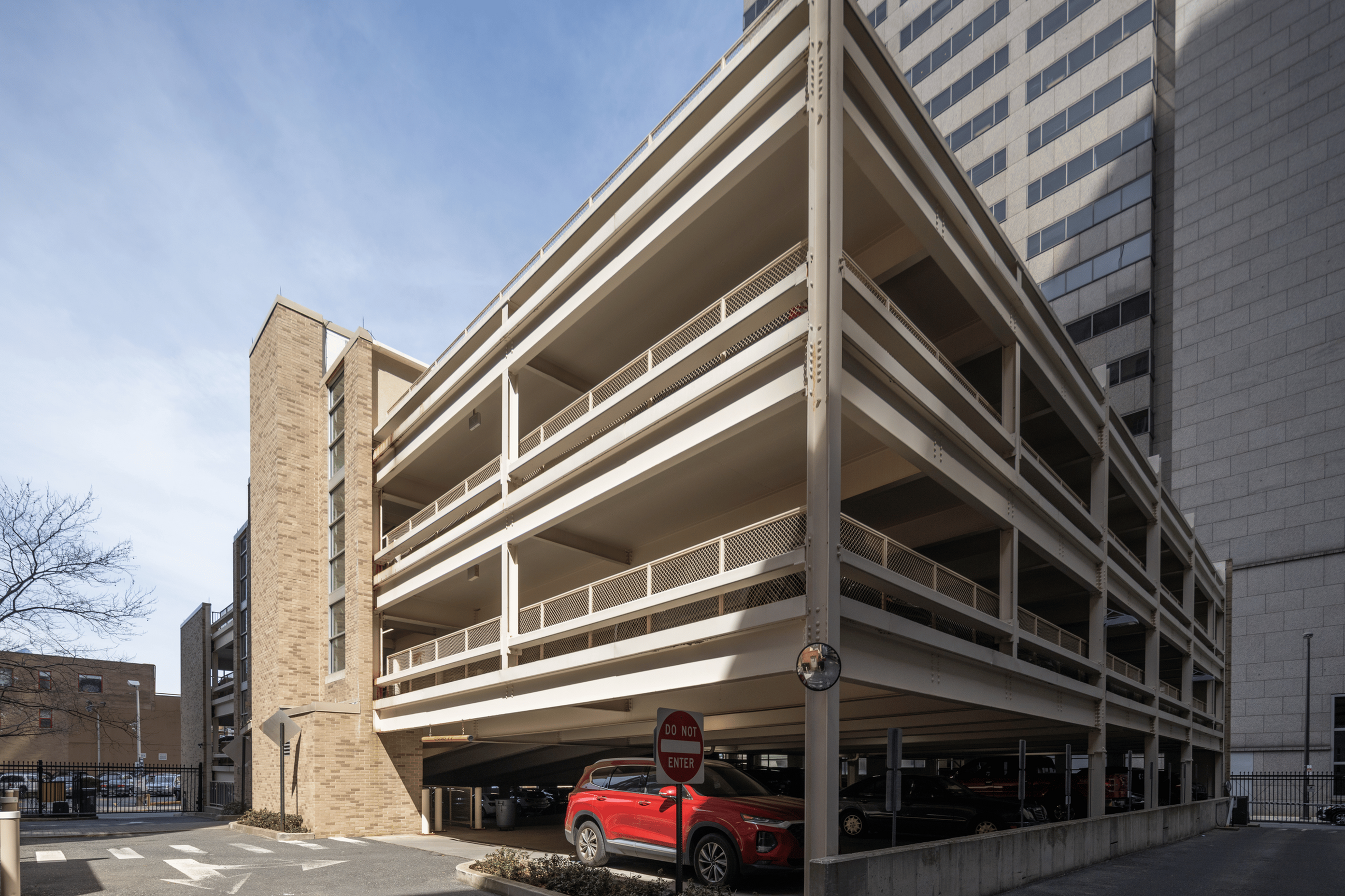 Modern multi-story parking structure with sleek architectural design and ample parking space.
