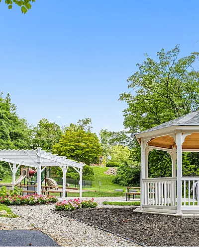 Beautiful garden view with a white gazebo and lush greenery.