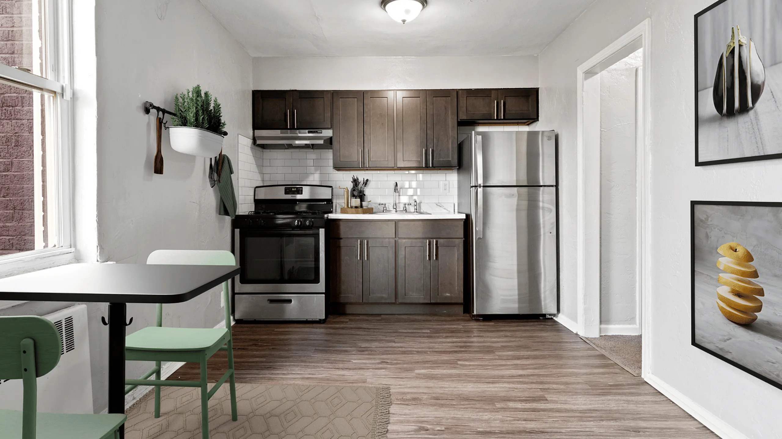Bright kitchen with modern appliances, dark wood cabinets, and cozy dining area.