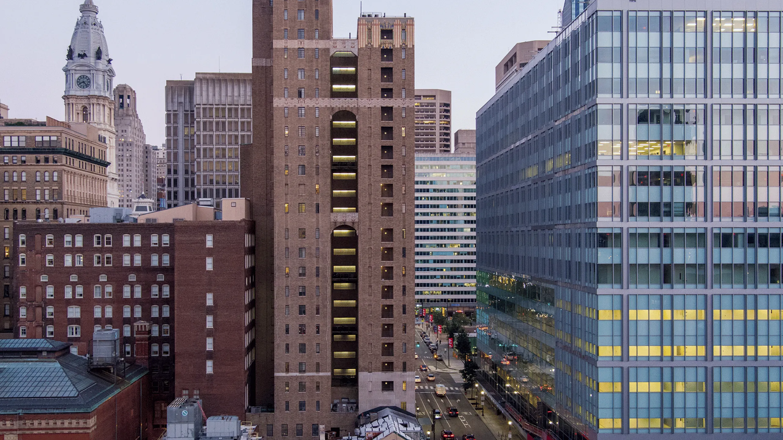 Captivating view of urban skyline featuring historic and modern architecture at dusk.