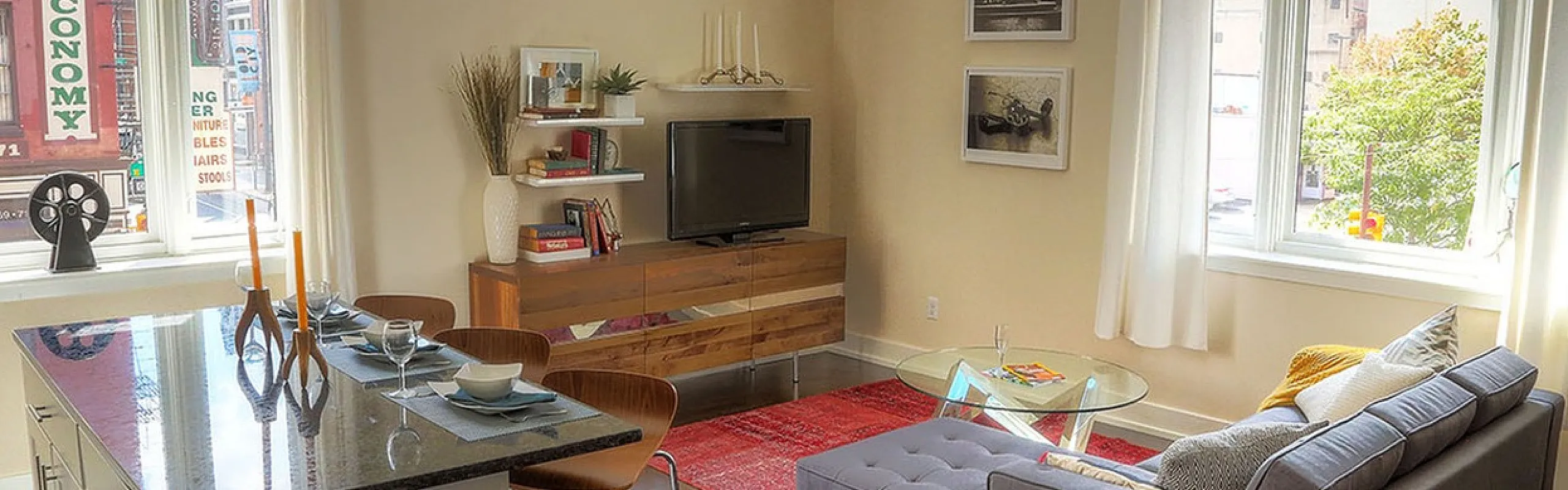 Bright and airy urban living room with modern furniture, large windows, and a cozy atmosphere.
