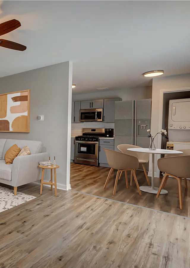 Contemporary living room with stylish decor, modern kitchen, and cozy seating in an open-concept design.