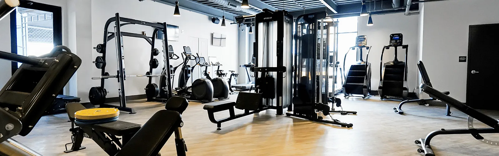 Modern fitness center with state-of-the-art exercise equipment and ample space, perfect for a comprehensive workout routine.