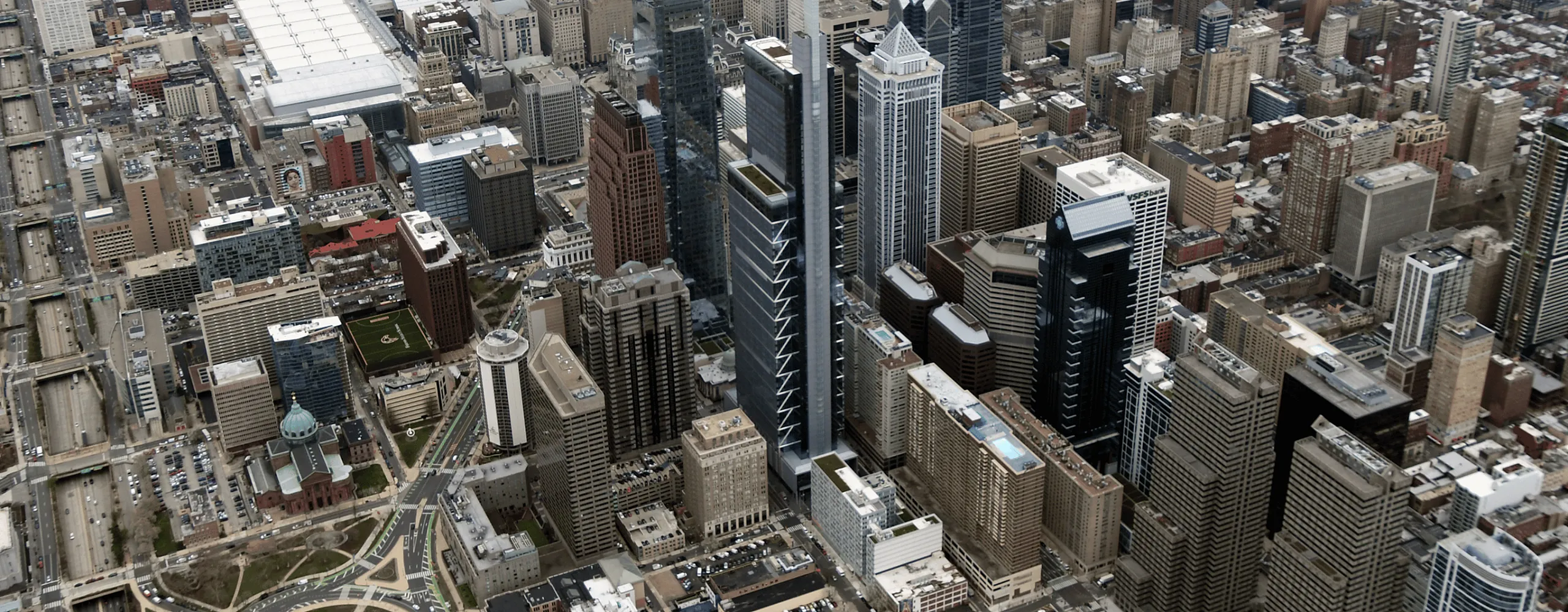Breathtaking aerial view of a bustling cityscape featuring modern skyscrapers, historic architecture, and a scenic riverside, ideal for urban living enthusiasts.