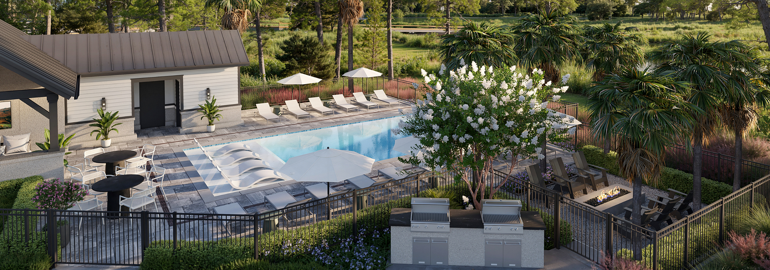 Tranquil pool area with lounge chairs, umbrellas, and lush greenery in a serene setting.