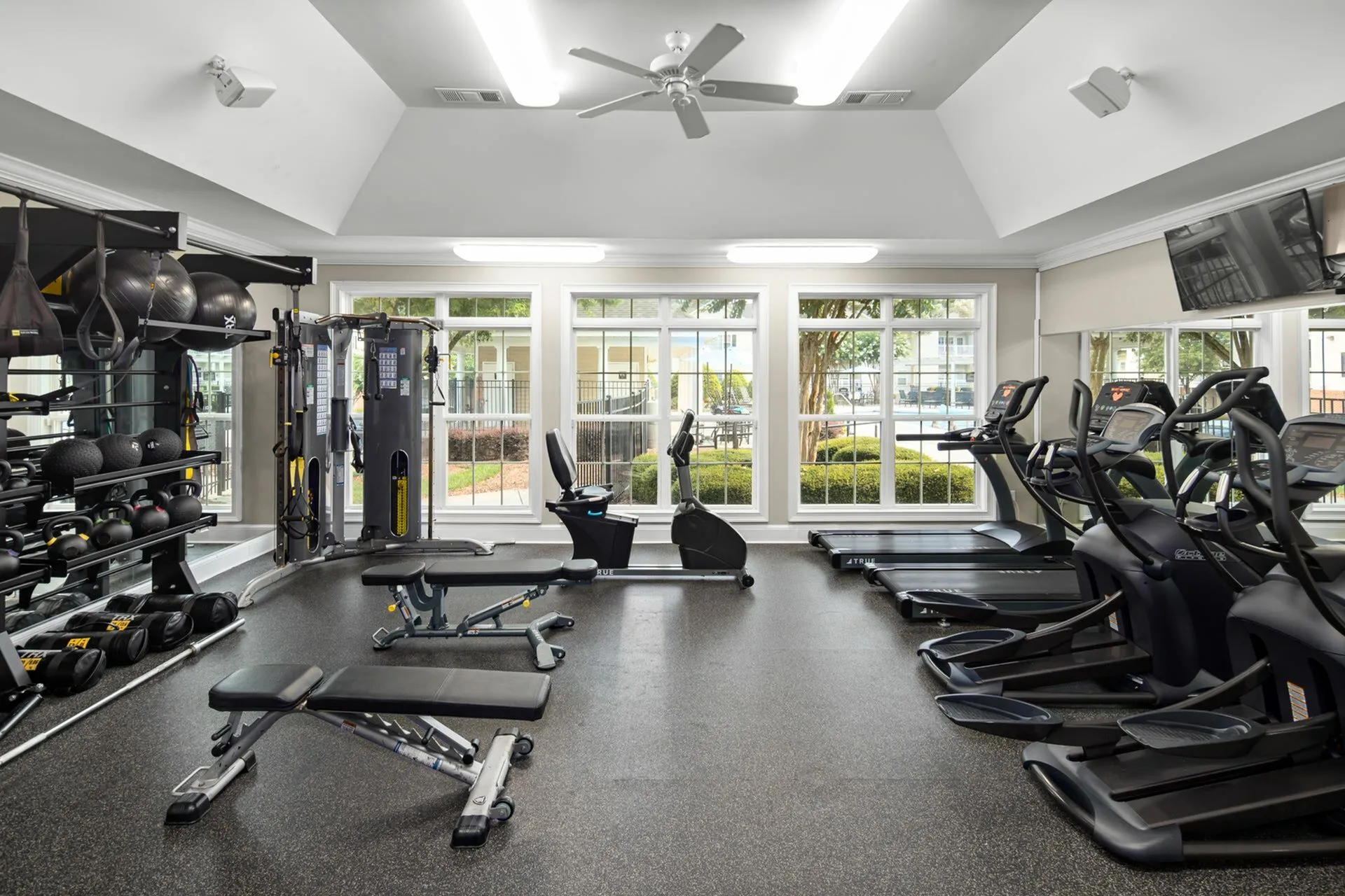 Gym with cardio and weight machines at Abberly Grove Apartments in Raleigh, NC