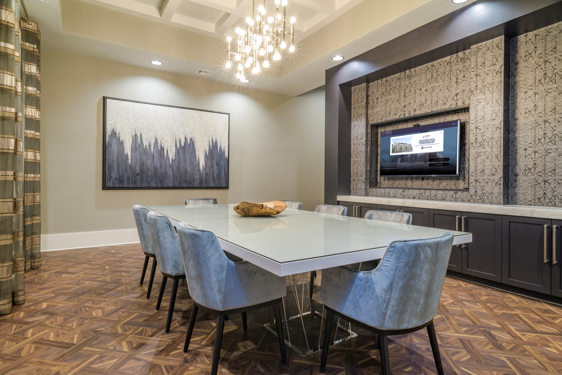 Elegant dining area showcasing a modern glass table with plush chairs, chic lighting, and contemporary artwork, perfect for sophisticated gatherings.