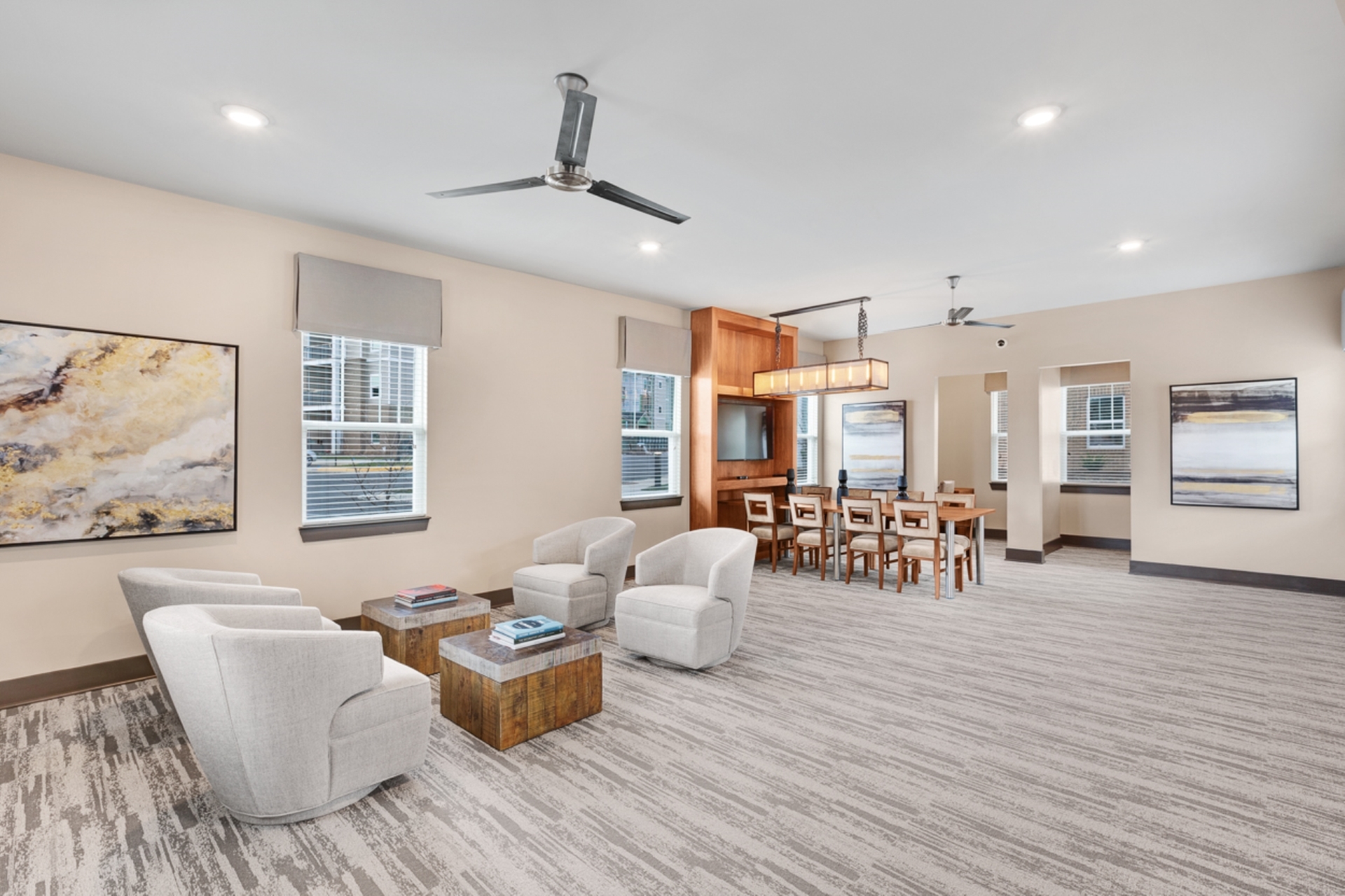 Elegant living and dining area with modern furnishings, warm lighting, and stylish artwork, perfect for entertaining.