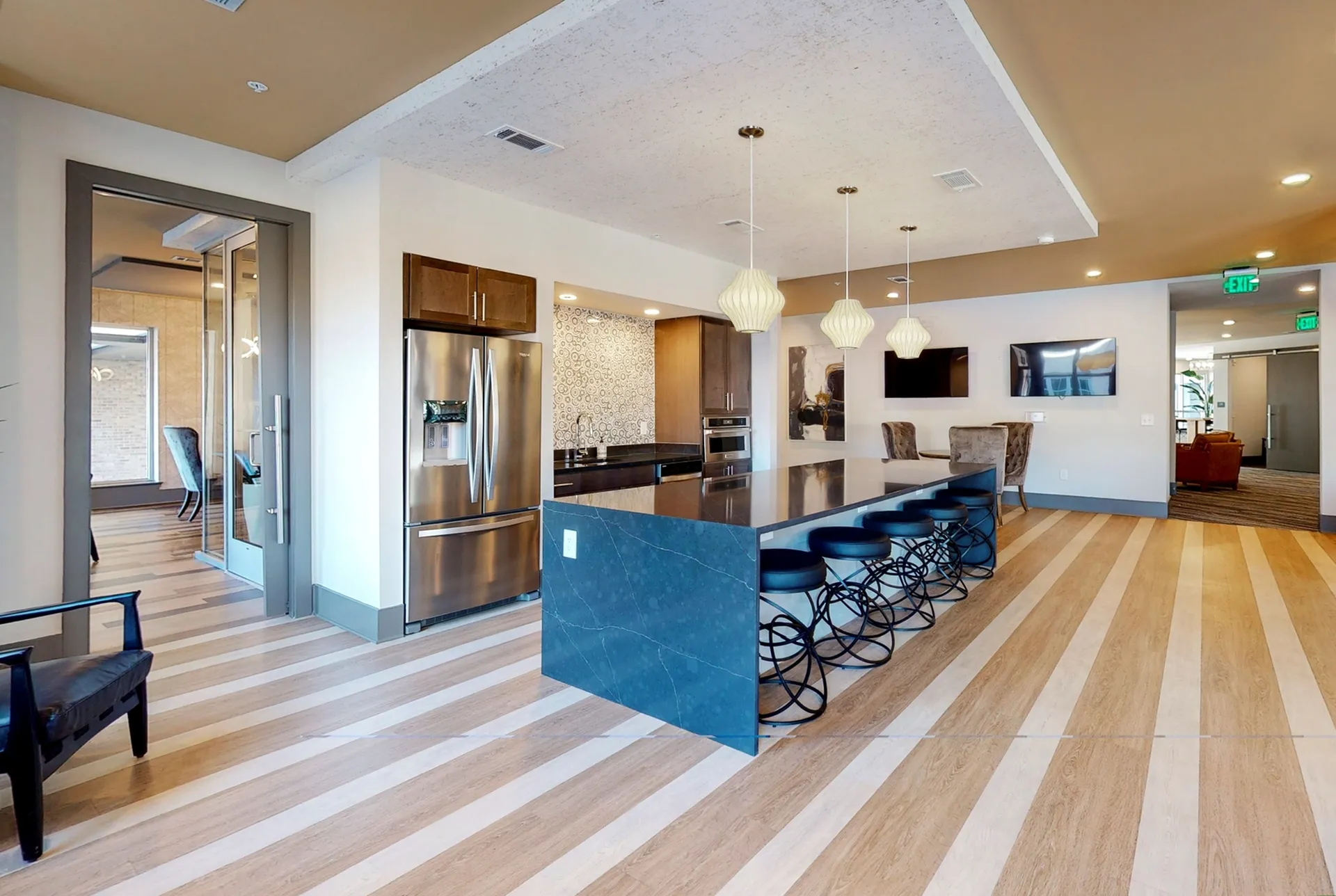 Modern kitchen with sleek stainless steel appliances, elegant pendant lighting, and a spacious marble island perfect for entertaining.