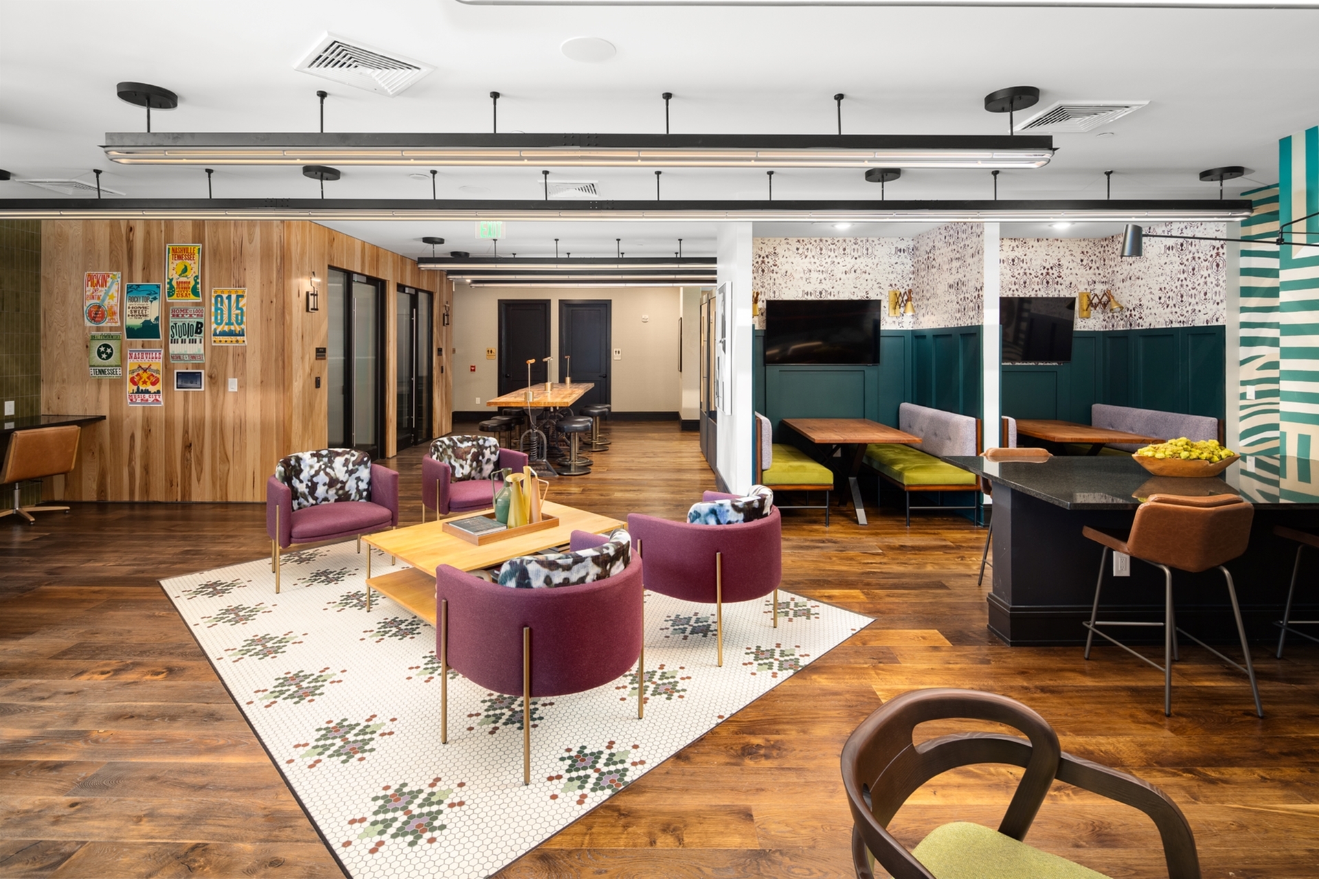 Modern communal space with vibrant seating, stylish art decor, and a cozy dining nook, perfect for socializing and relaxation.