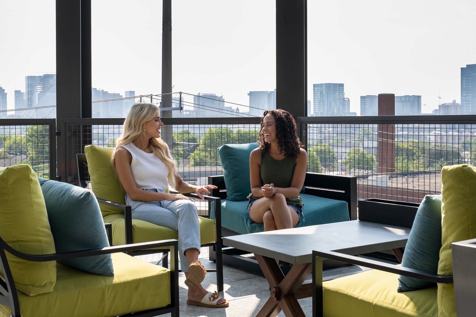 Vibrant rooftop lounge with comfortable seating, offering stunning cityscape views for relaxing conversations.