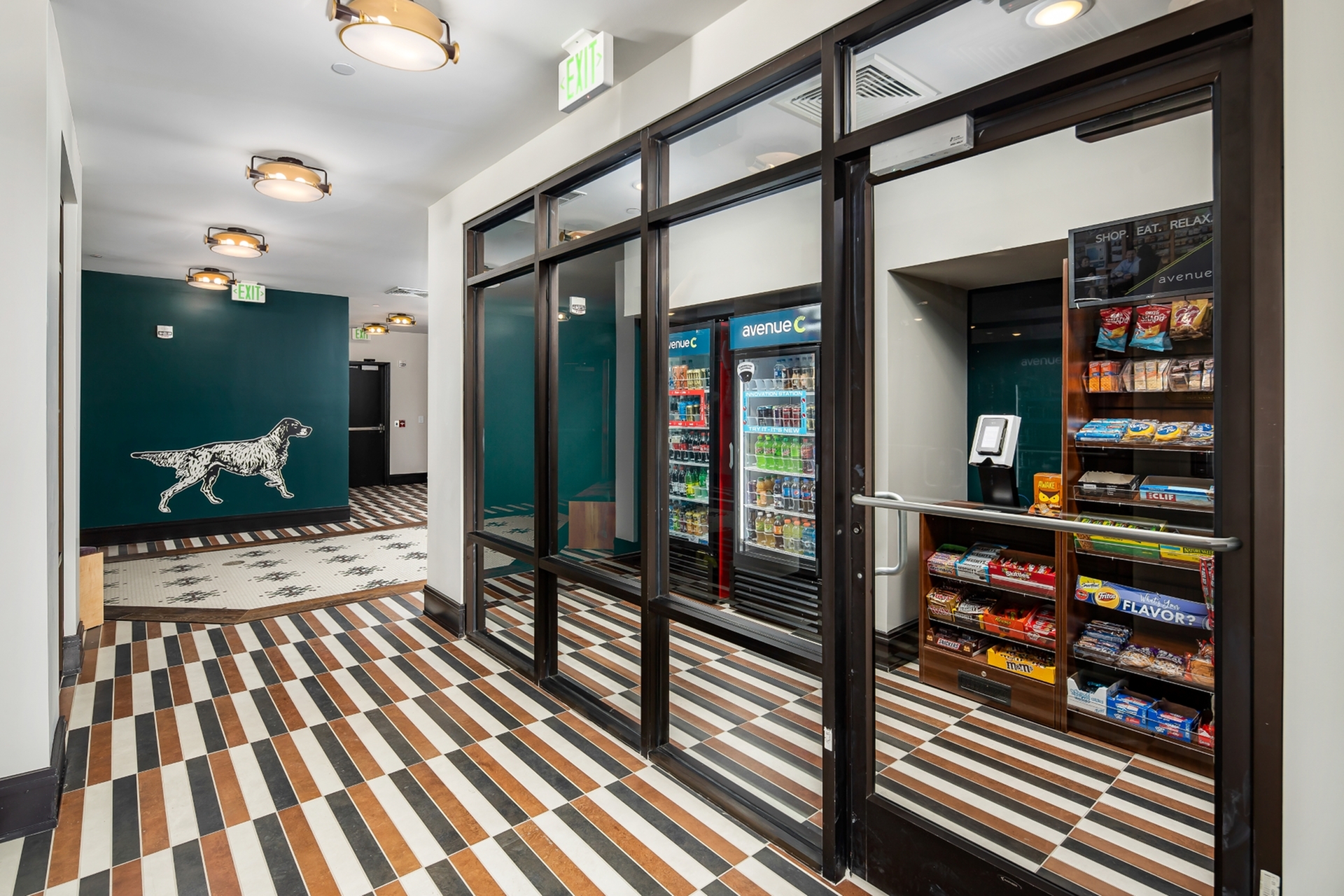 Modern apartment complex interior featuring a snack shop with vibrant striped floors and sleek lighting.