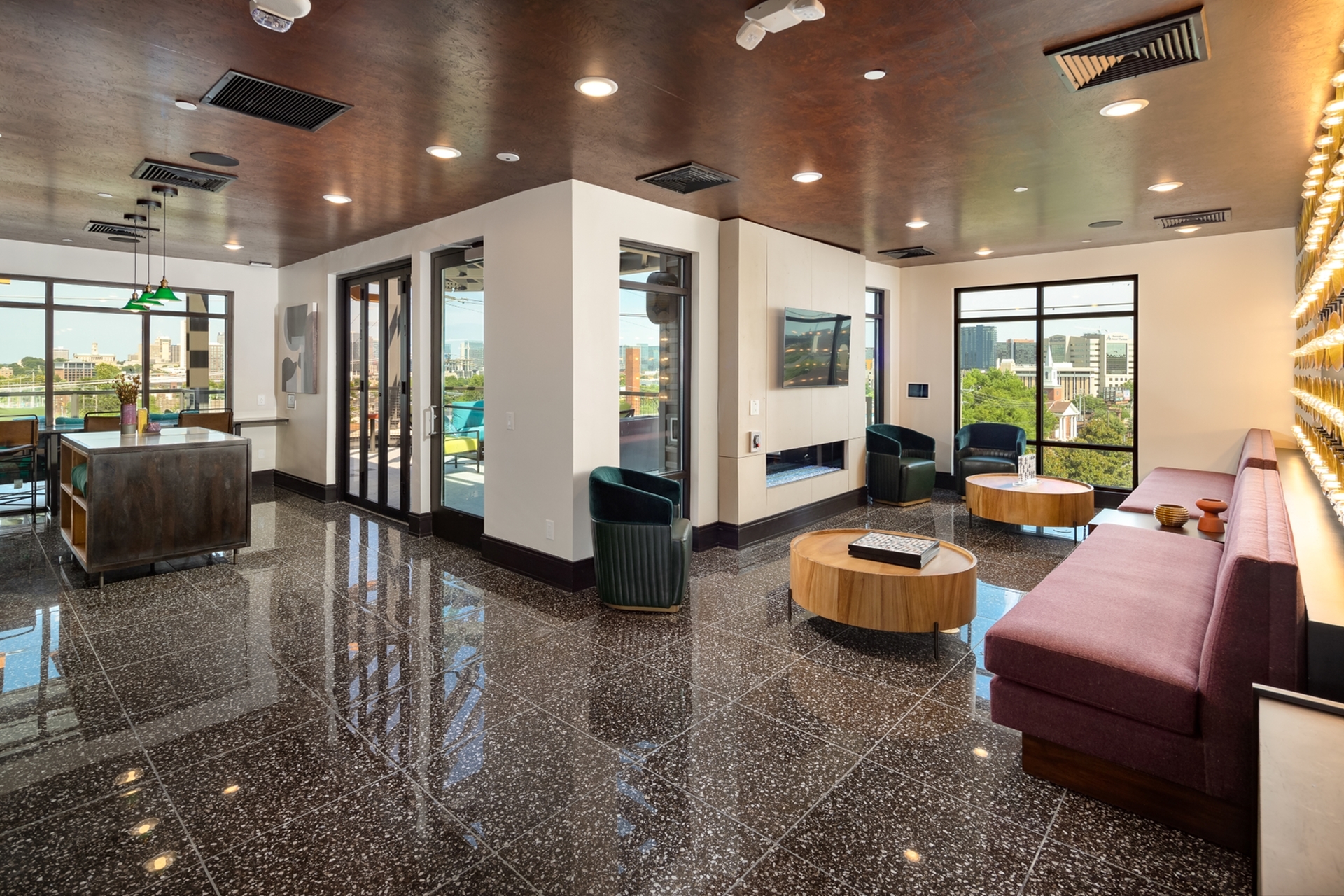 Chic and contemporary living space with glossy marble flooring, plush seating, and panoramic city views through expansive windows.
