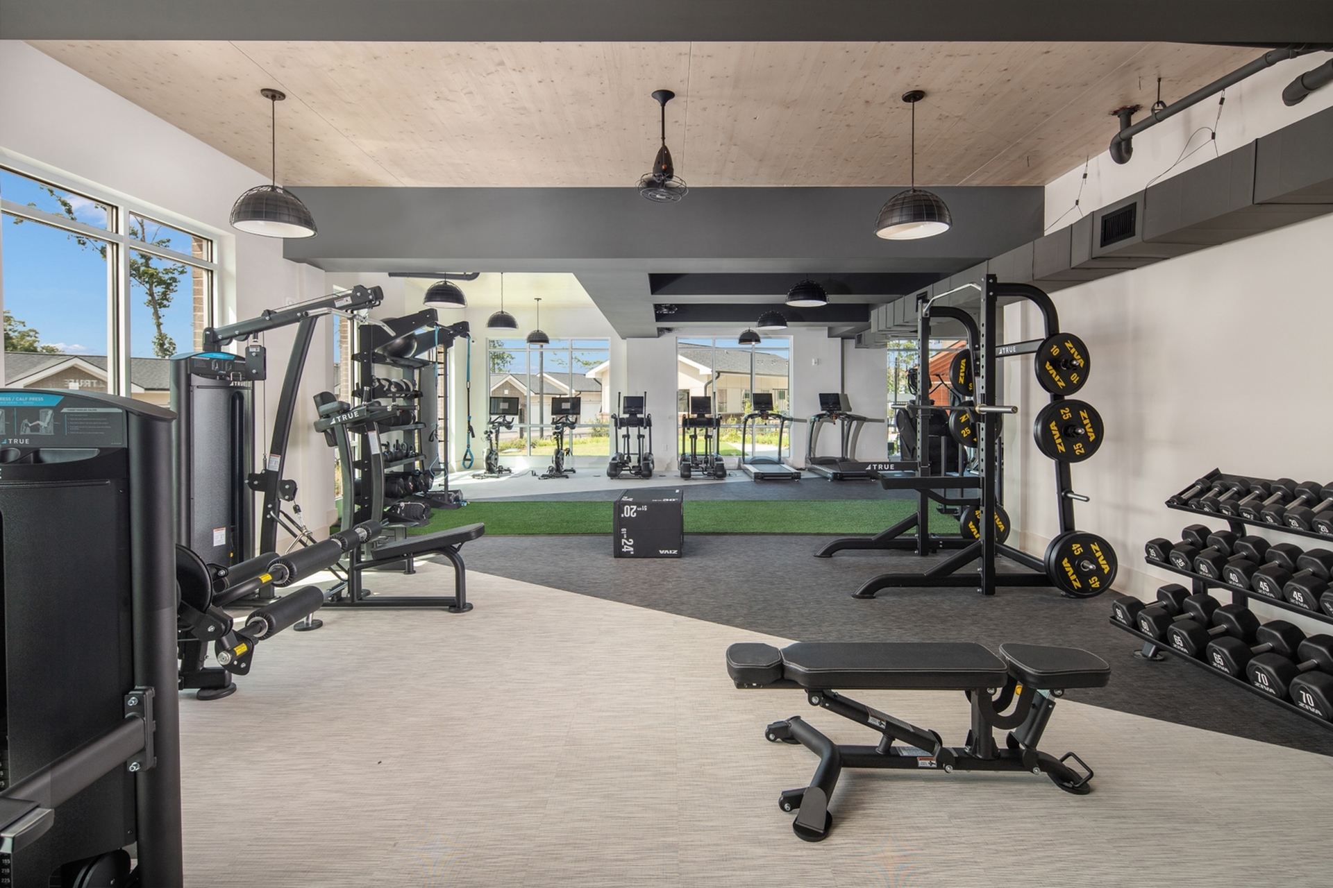 Modern fitness center with state-of-the-art equipment, bright lighting, and a welcoming atmosphere.