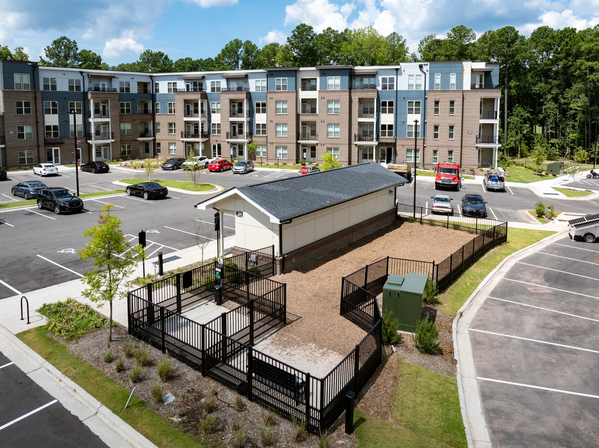 Modern apartment complex with stylish architecture, spacious parking, and lush green surroundings, offering a perfect balance of comfort and convenience.