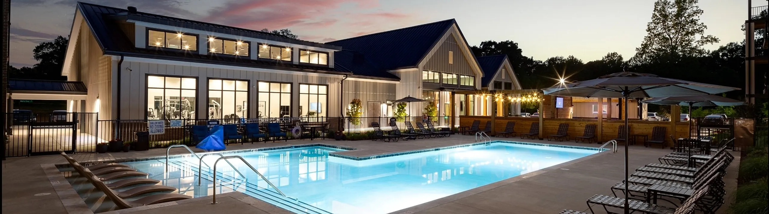 Resort Style Swimming Pool at dusk at Abberly Liberty Crossing Apartments in Charlotte, NC