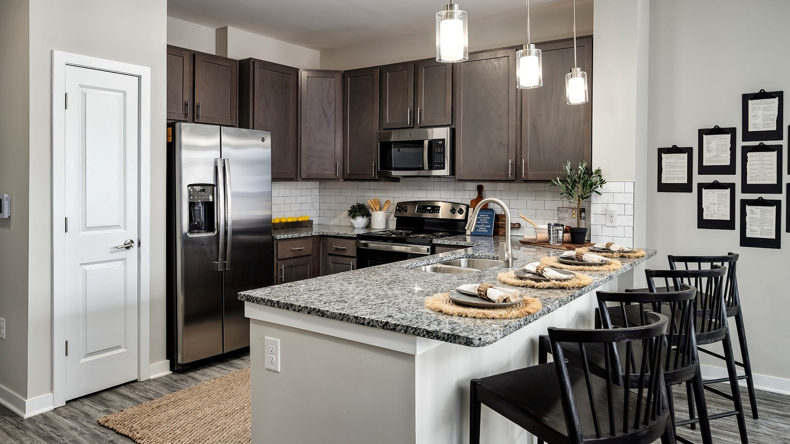 A kitchen with a breakfast bar at Abberly Alston Townhomes in Cary, NC
