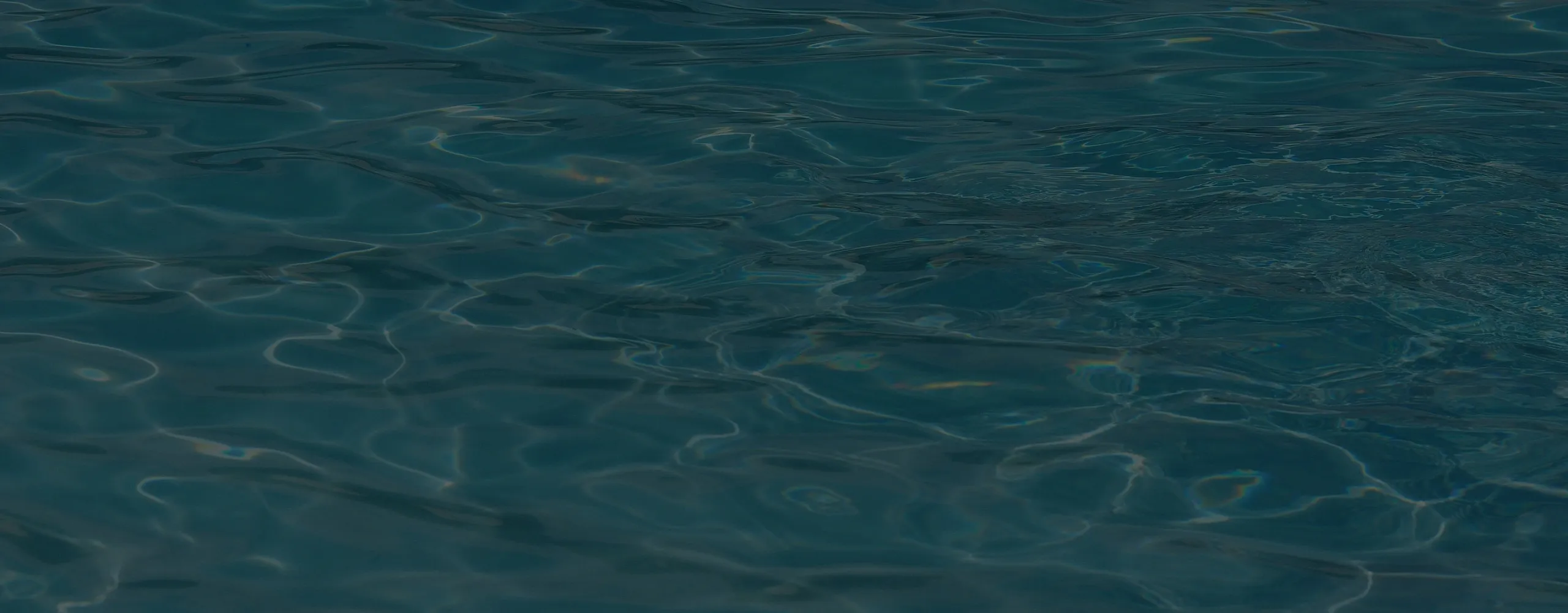 Close-up of dark, rippling water with subtle reflections on the surface.