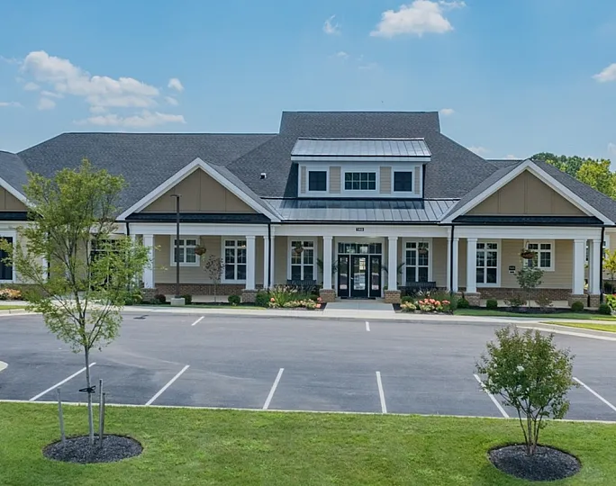Charming community clubhouse surrounded by lush greenery and modern living spaces, perfect for vibrant social gatherings.