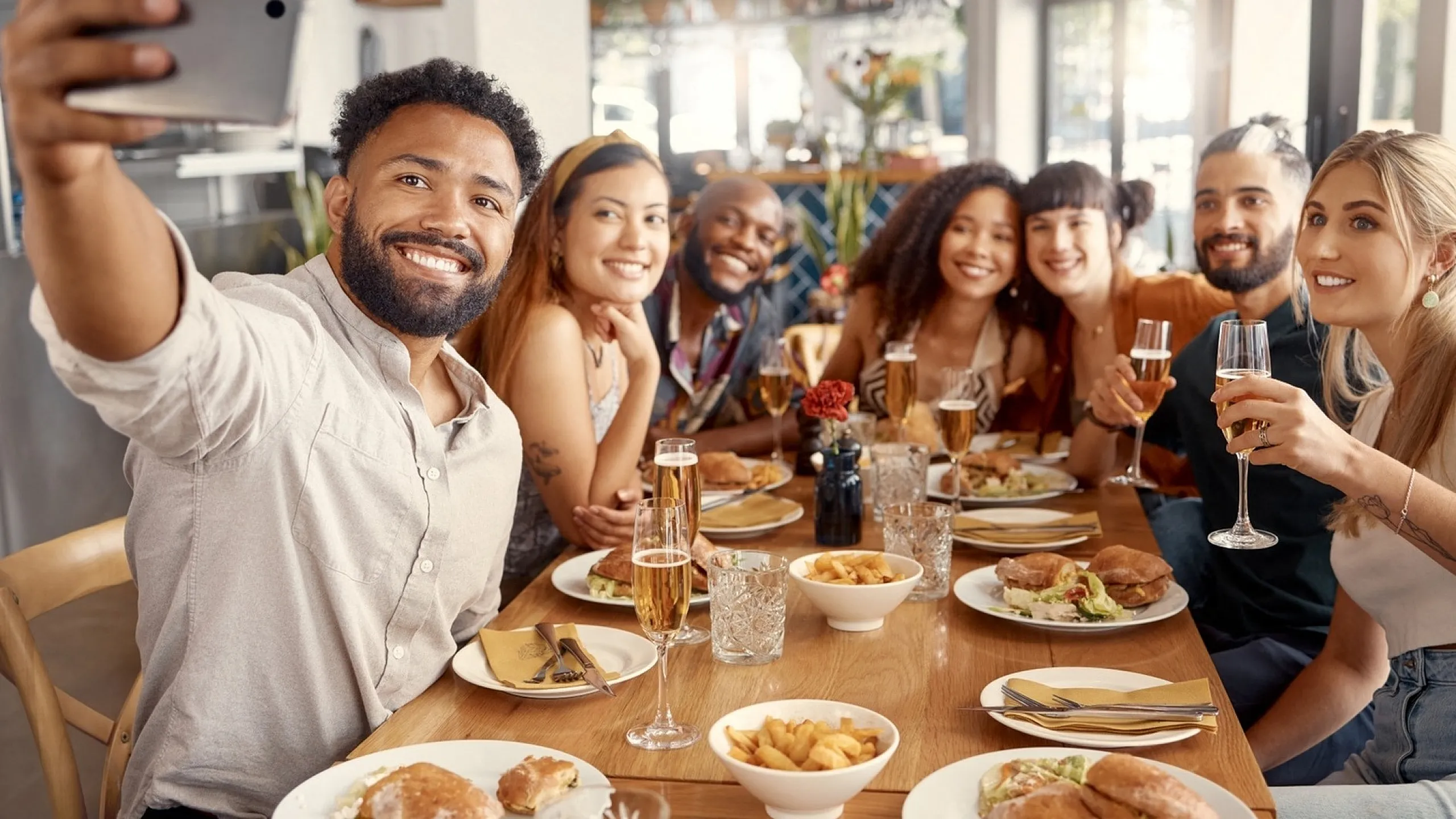 Lively group enjoying a meal together at a trendy restaurant, capturing the joy of dining with friends.
