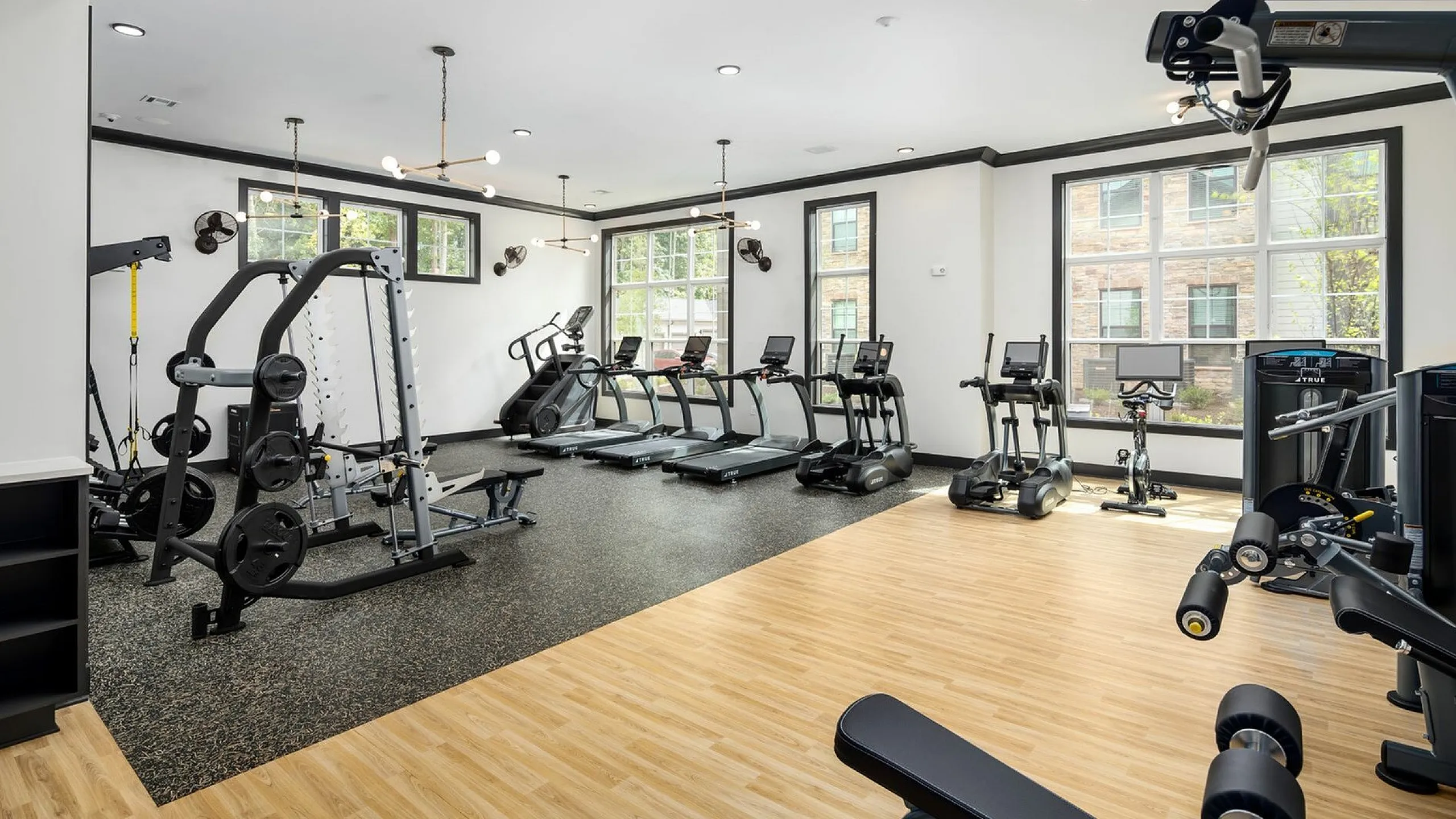Modern fitness center featuring state-of-the-art gym equipment, sleek treadmills, and bright natural lighting for an energizing workout experience.