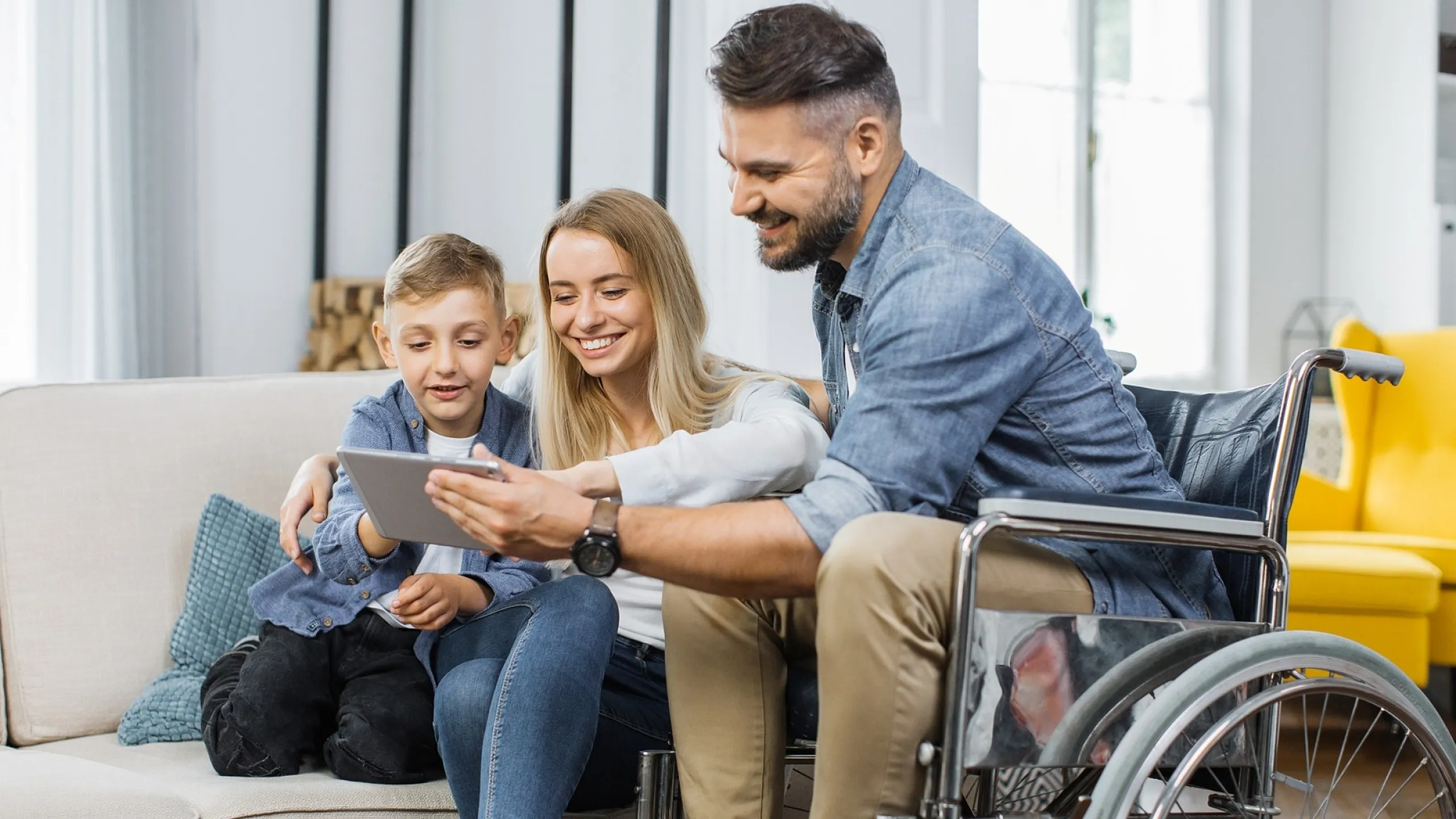 Bright and welcoming living room with a joyful family enjoying a tablet together, showcasing family-friendly space.