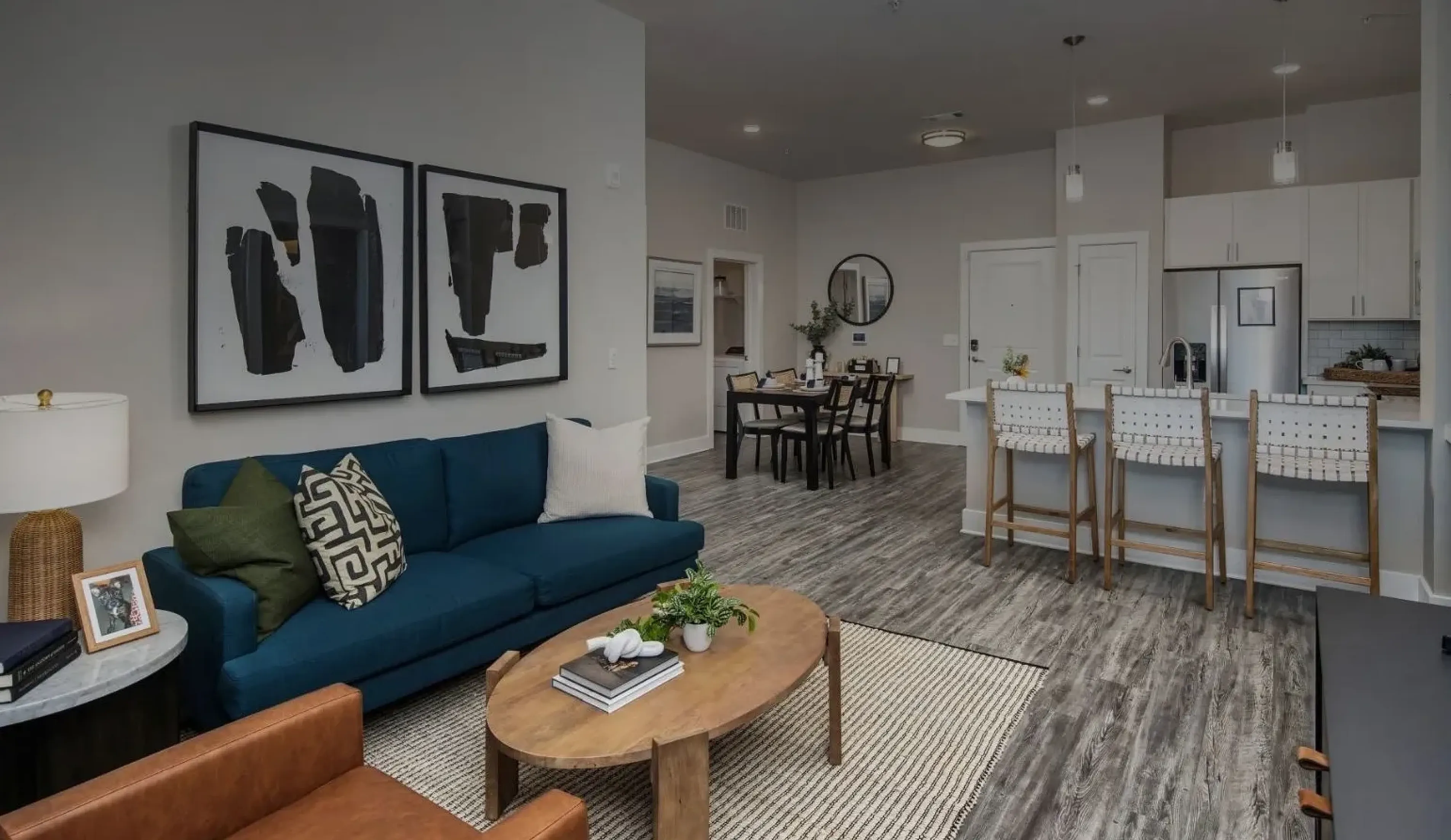 Modern apartment interior at Abberly Commons in Raleigh, NC, with an open-concept layout, contemporary kitchen, dining area and spacious living room.
