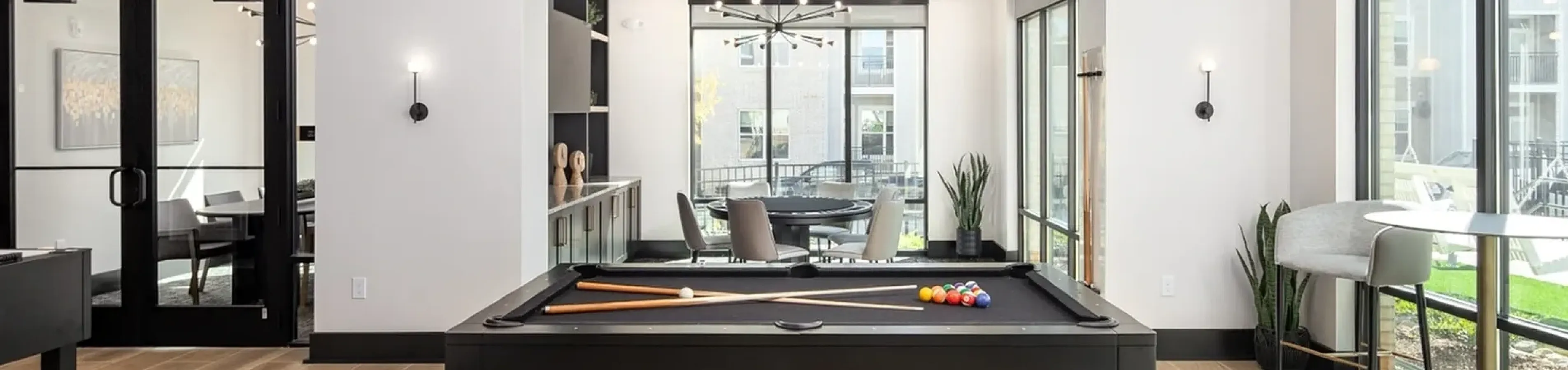Clubroom with billiards table and modern seating at Abberly Commons in Raleigh, NC.