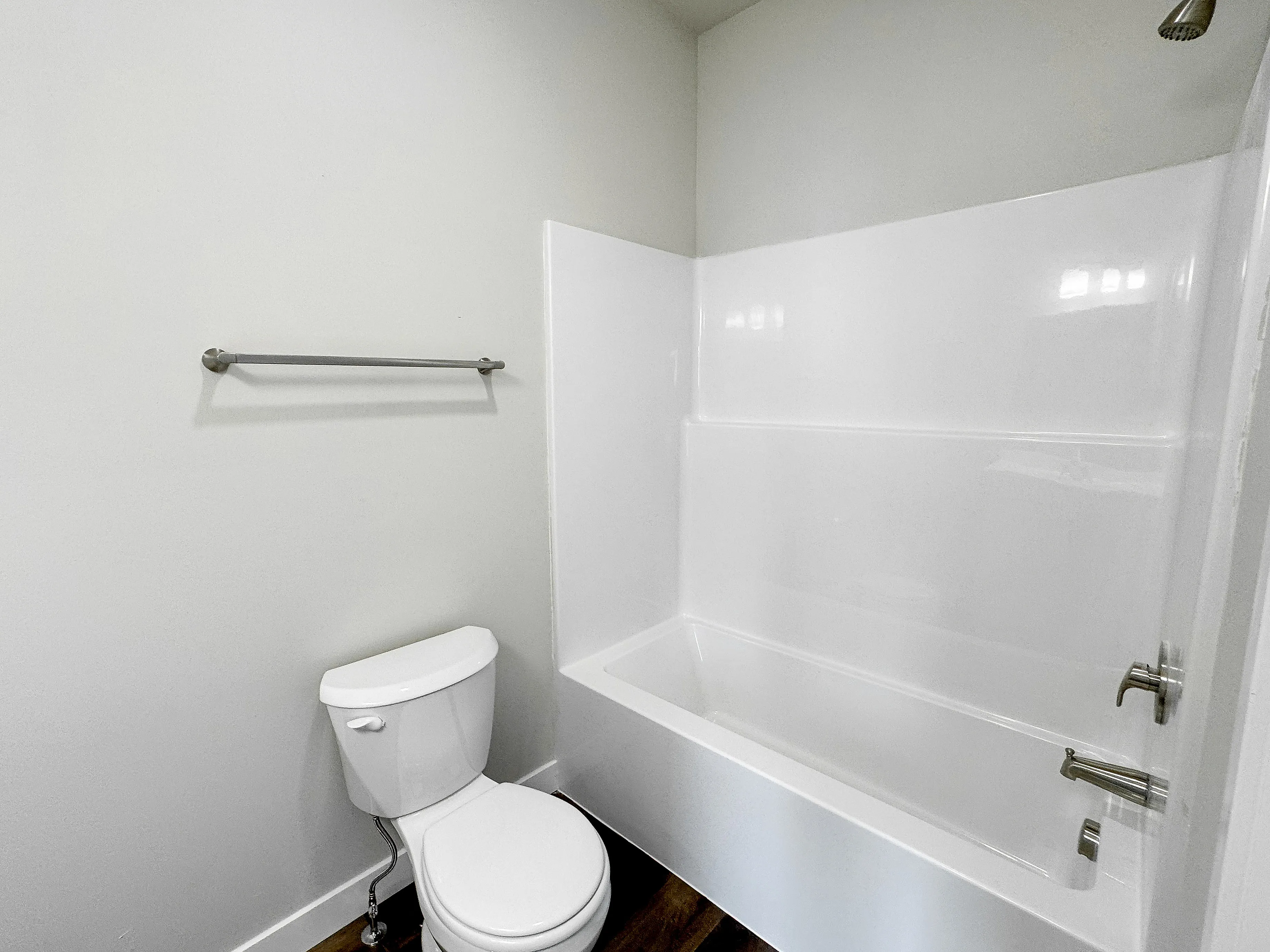 Contemporary bathroom with sleek white bathtub, modern fixtures, and elegant design.
