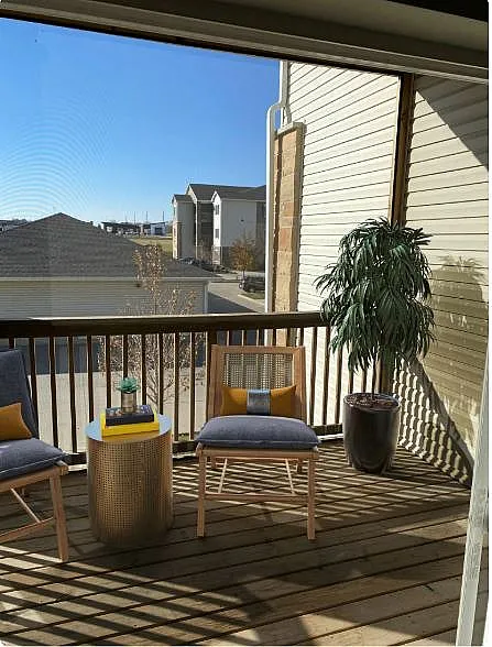 Charming balcony with cozy seating, vibrant décor, and scenic views, perfect for relaxation.