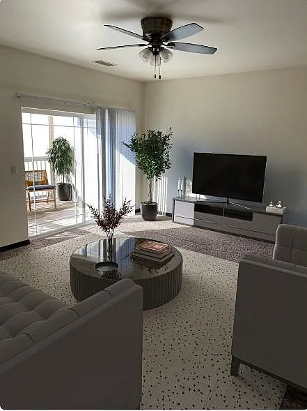 Contemporary living room with sleek furniture, large TV, and natural light from glass doors leading to a charming balcony with plants.
