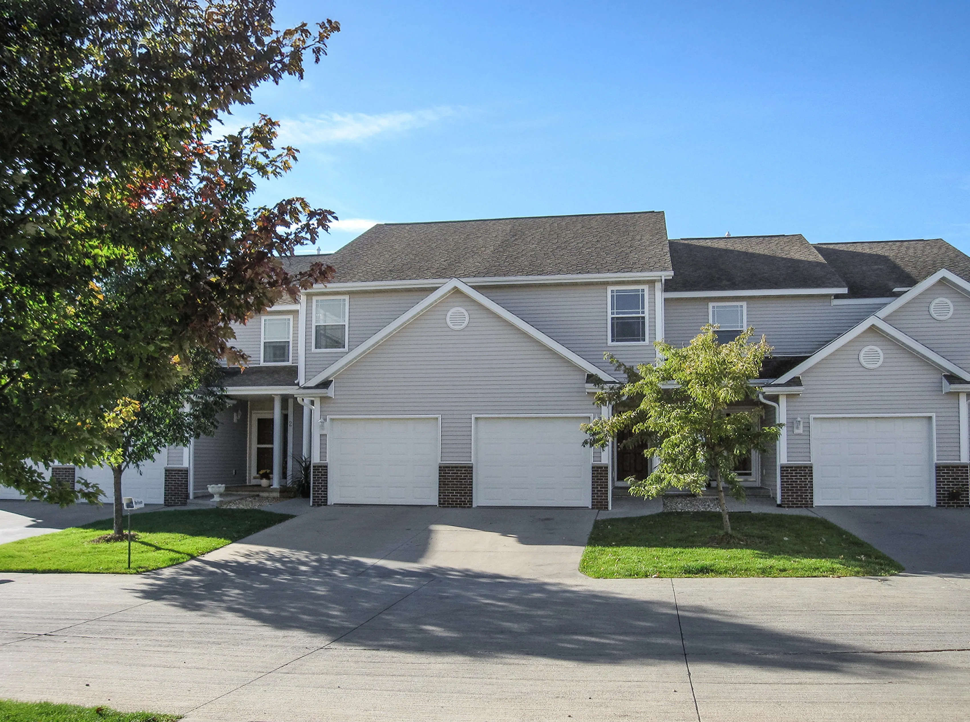 Charming suburban townhouse with modern architecture, two-story design, and spacious garage entry.