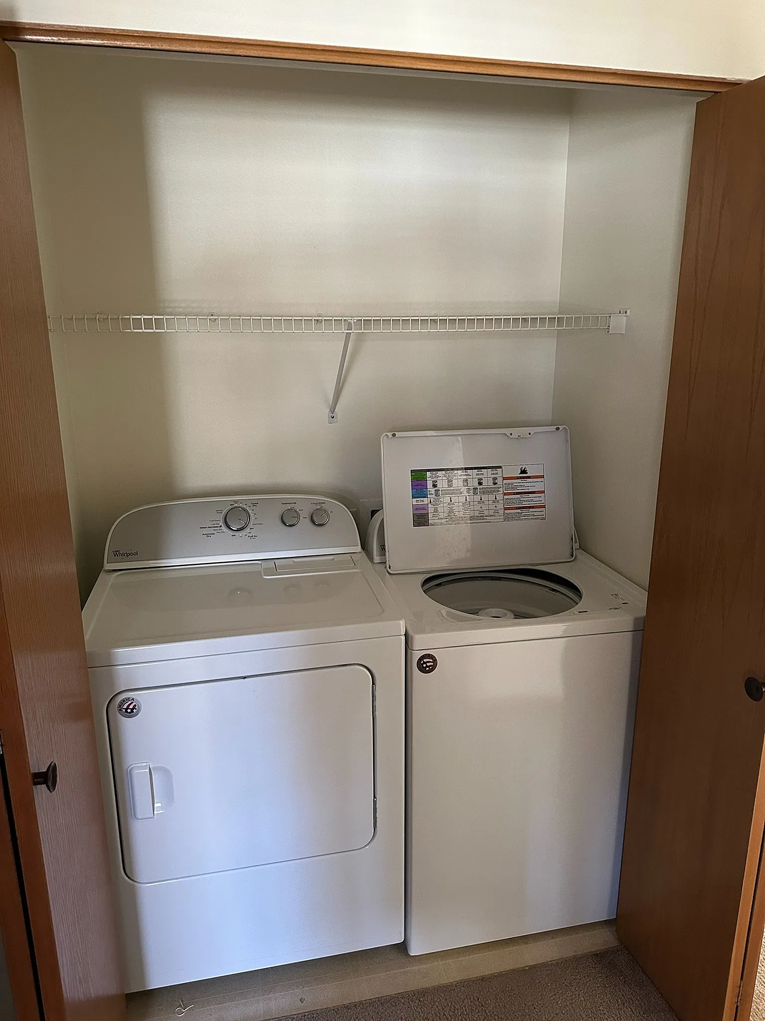 Convenient in-unit laundry closet with modern washer and dryer, optimized for efficient living.