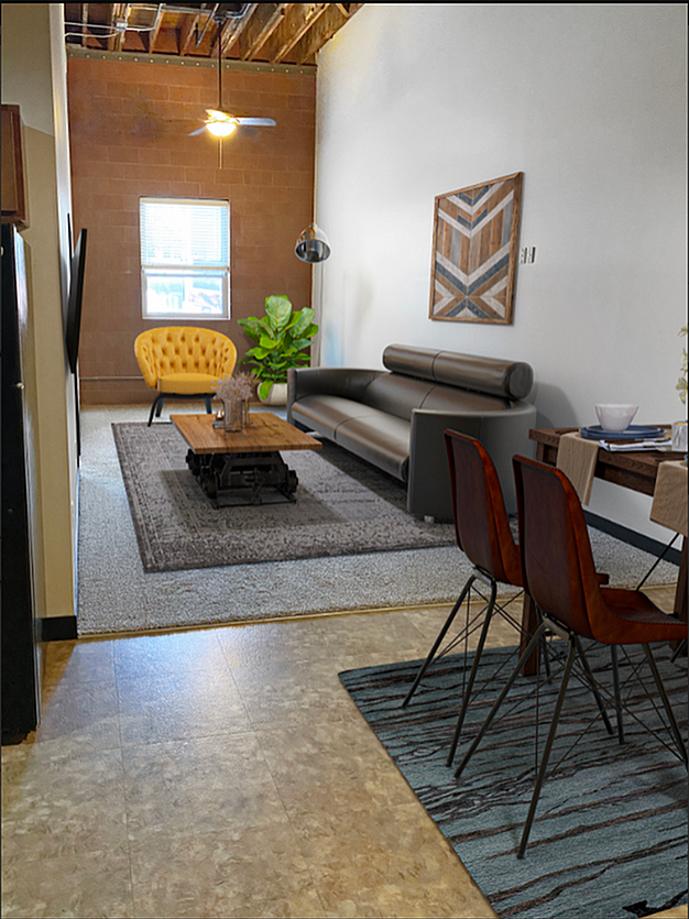 Chic apartment interior with modern decor, featuring a cozy living area with a stylish sofa and vibrant yellow chair, complemented by elegant dining space and artistic accents.