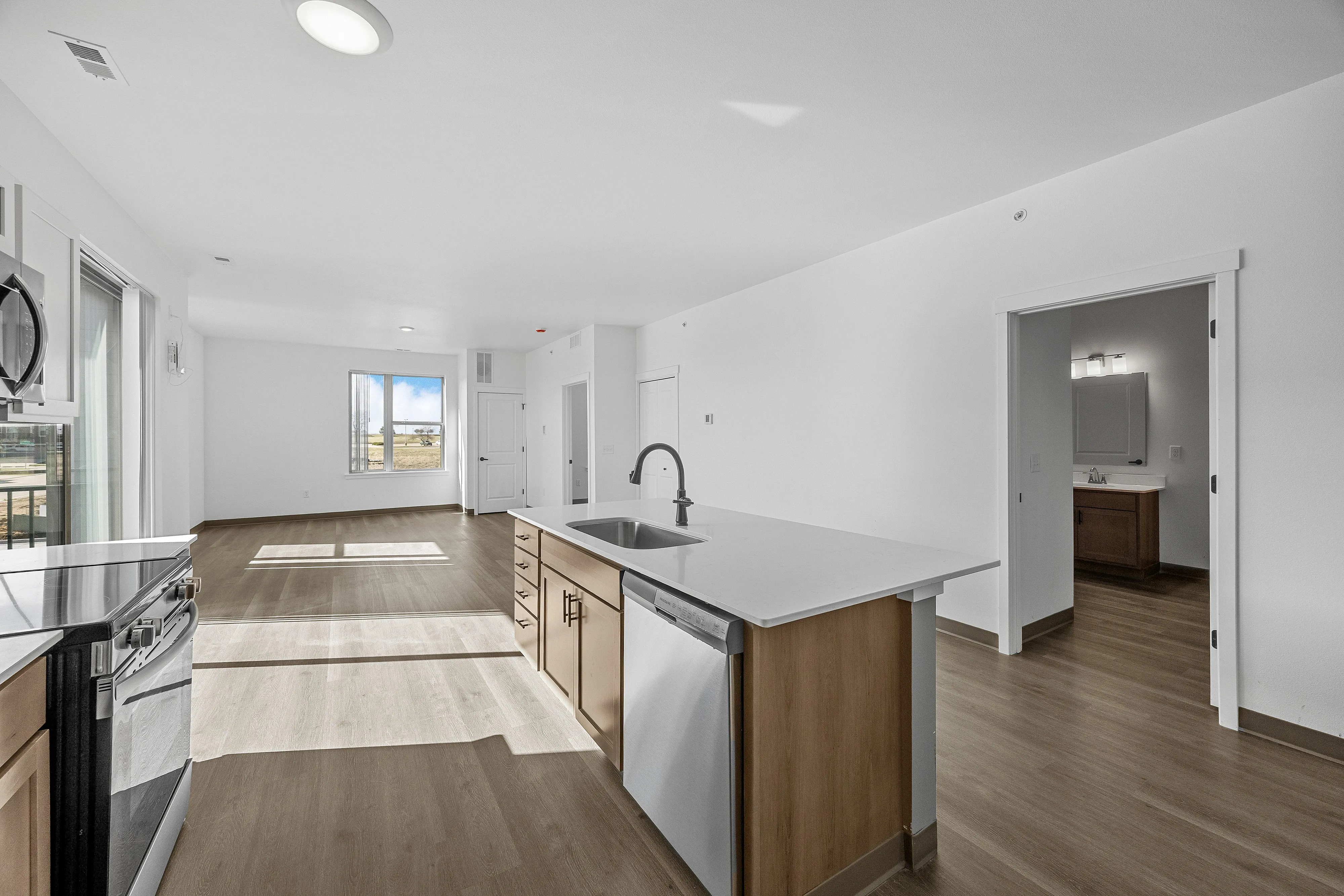 Bright and modern open-concept kitchen and living space with sleek finishes and abundant natural light.