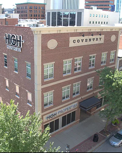 Charming brick building by High Properties with urban views, perfect for city living.