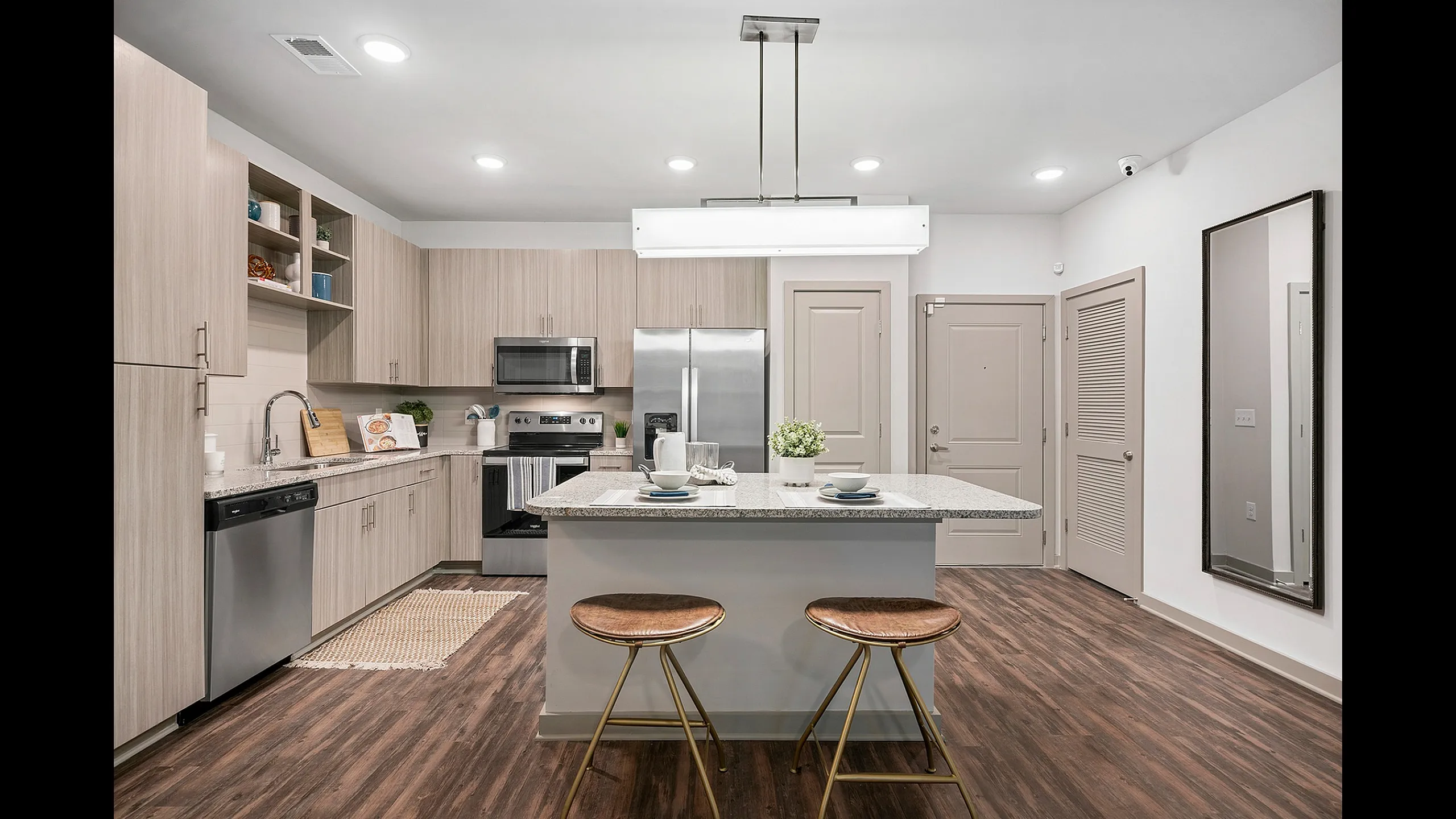 Modern kitchen with sleek cabinets, granite countertops, and stylish island seating, perfect for culinary enthusiasts.