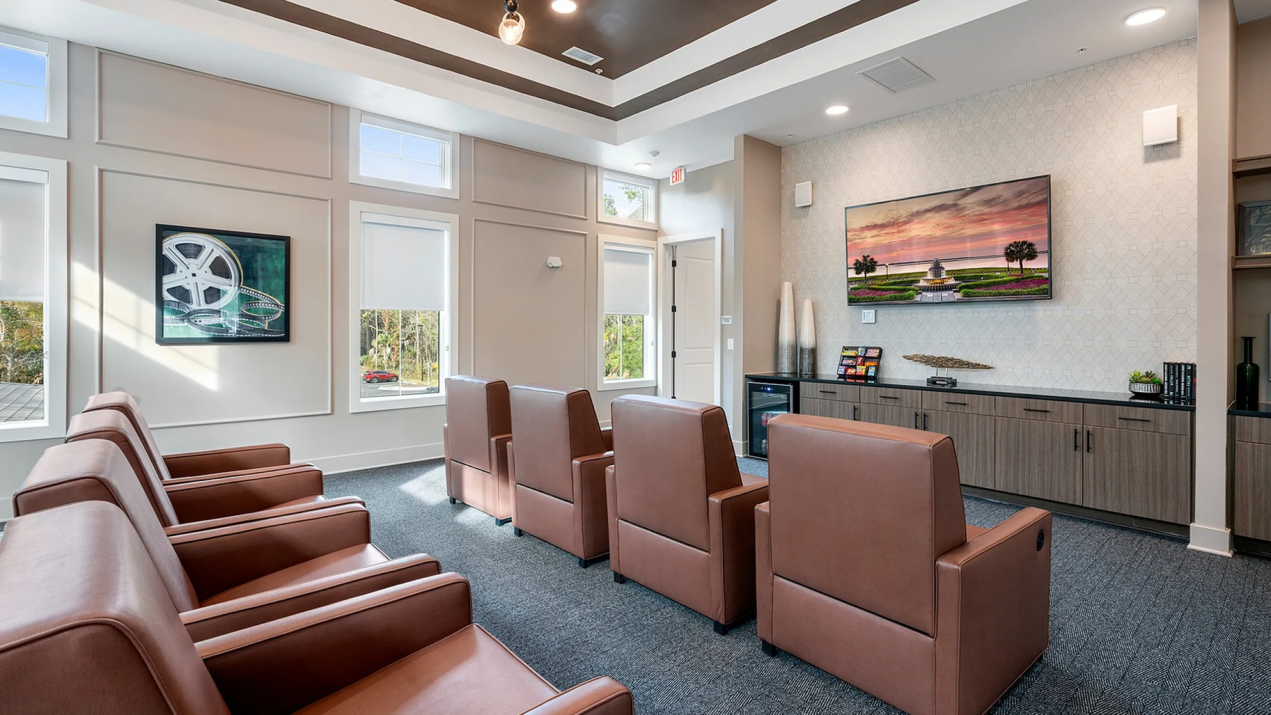 Luxurious apartment media room with modern leather seating, ambient lighting, and elegant wall decor.