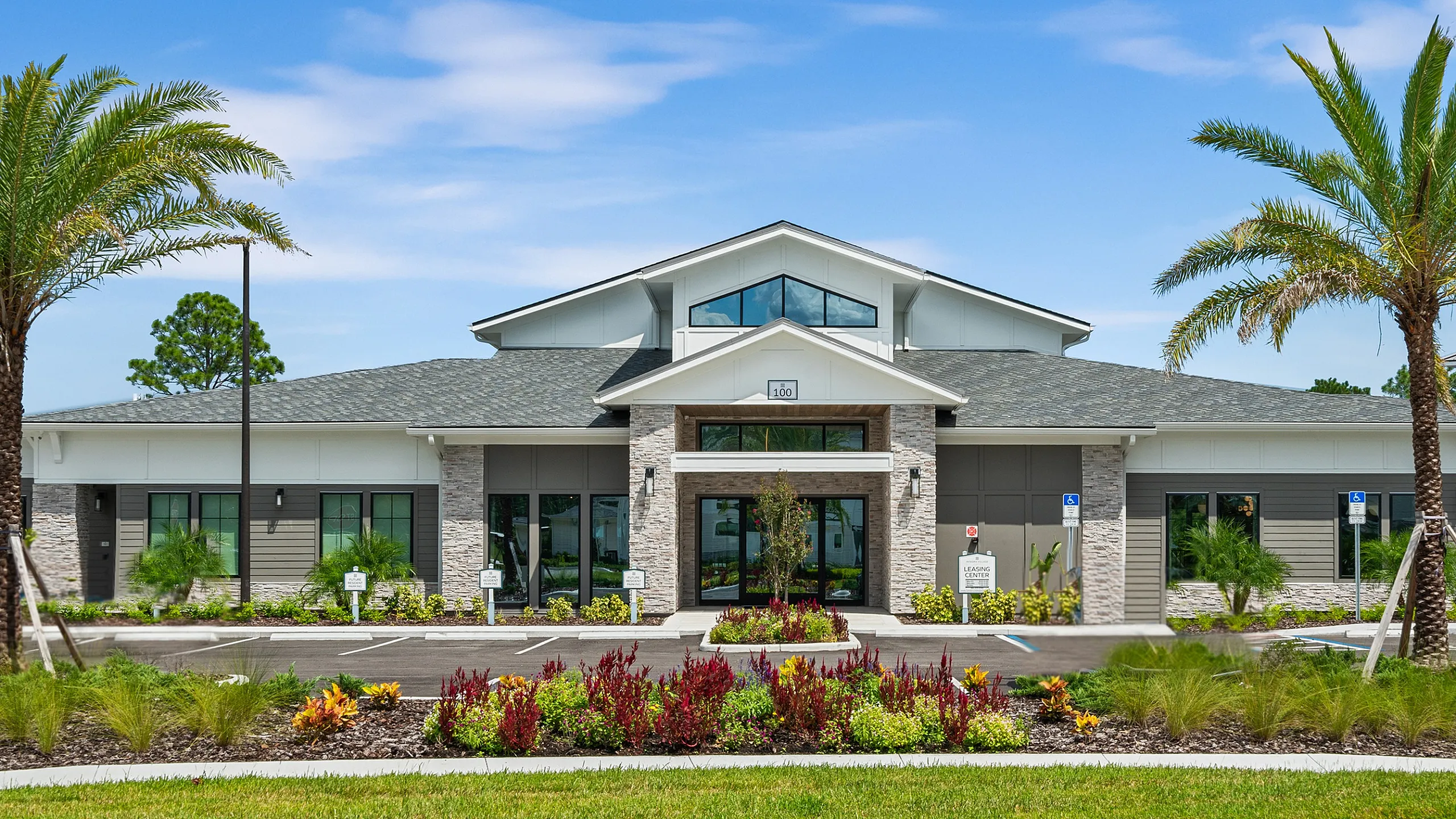 Inviting community clubhouse with modern architecture, surrounded by lush landscaping and palm trees in a serene setting.