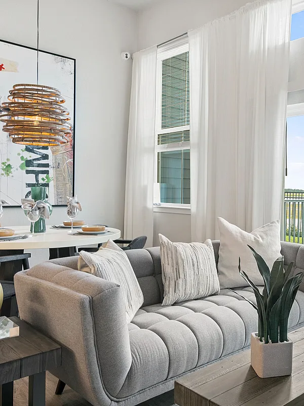 Bright and modern living room with elegant decor and expansive balcony view, perfect for relaxation and entertaining.