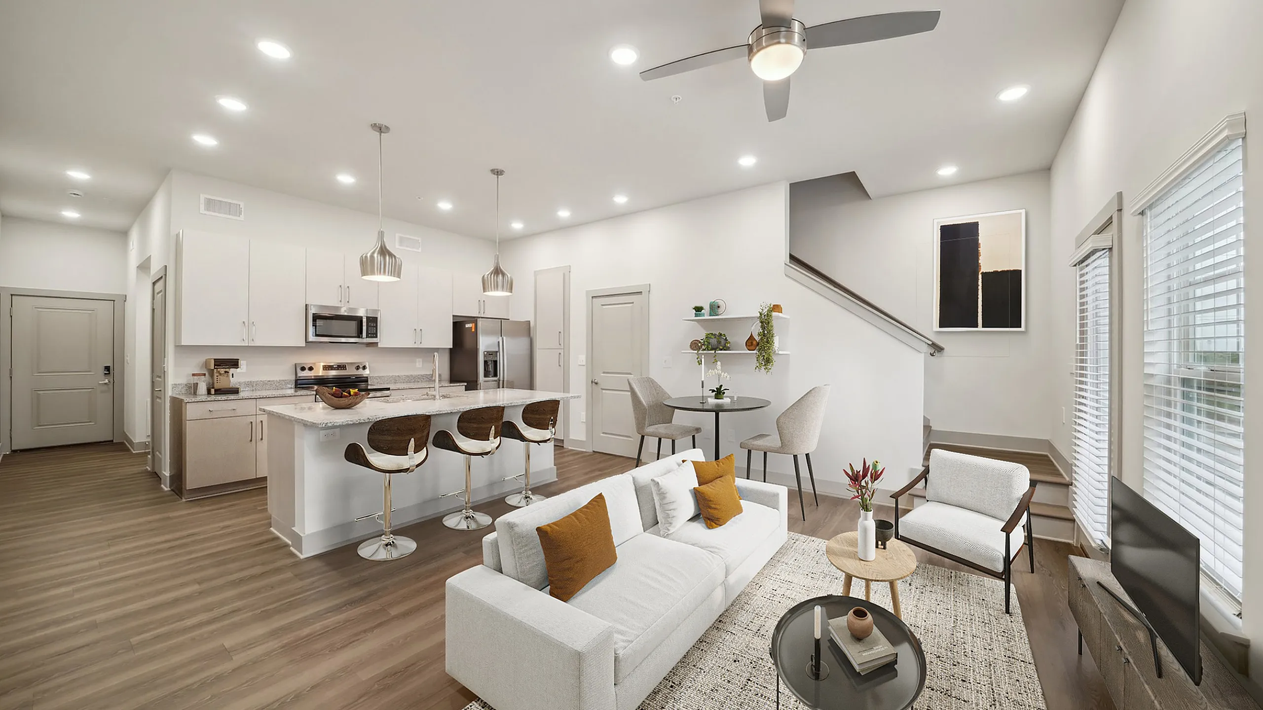 Modern open-plan living area with sleek kitchen, stylish breakfast bar, and cozy seating space, perfect for entertaining and relaxation.