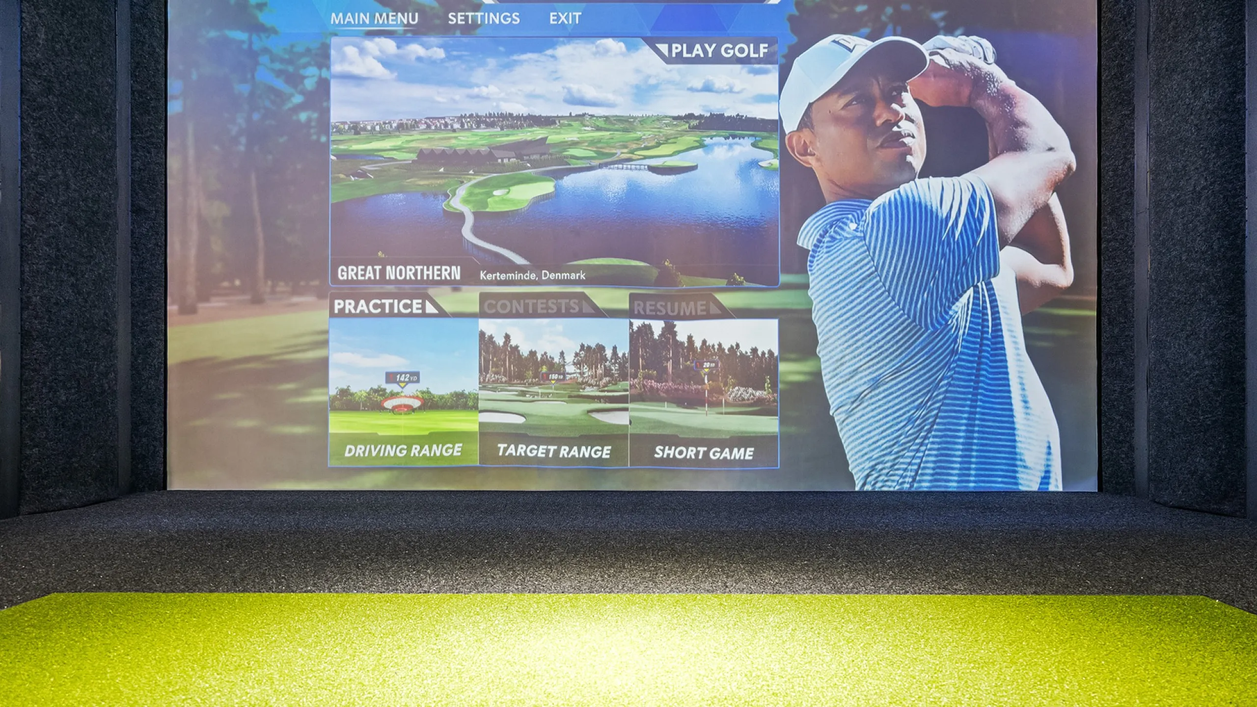 State-of-the-art virtual golf simulator showcasing a vivid golf course interface with practice options, providing an immersive playing experience indoors.