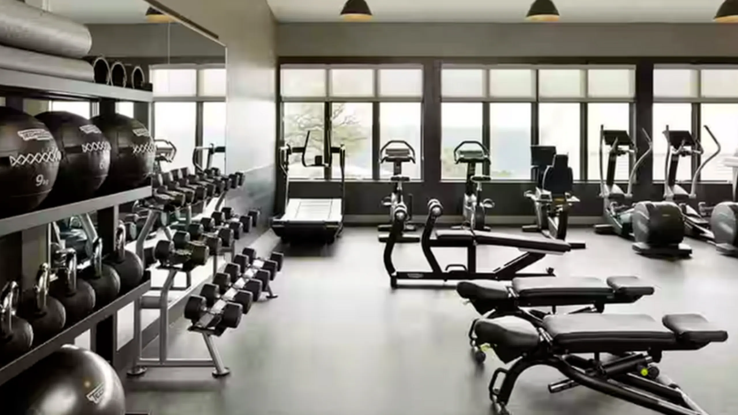Modern fitness center with state-of-the-art equipment and natural lighting, perfect for energizing workouts.