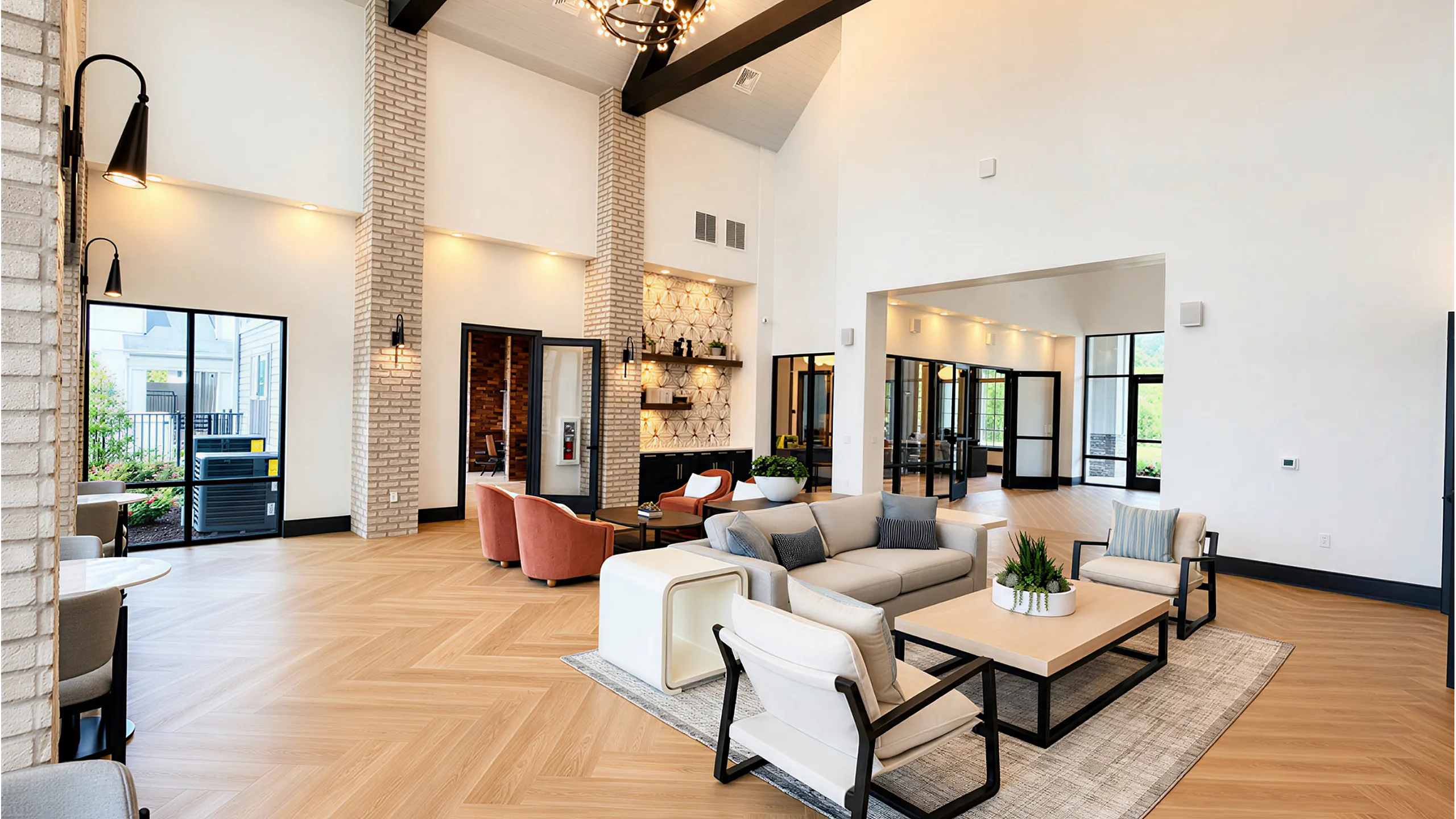 Luxurious modern living room featuring high ceilings, elegant chandeliers, and stylish furniture in a spacious open concept design.