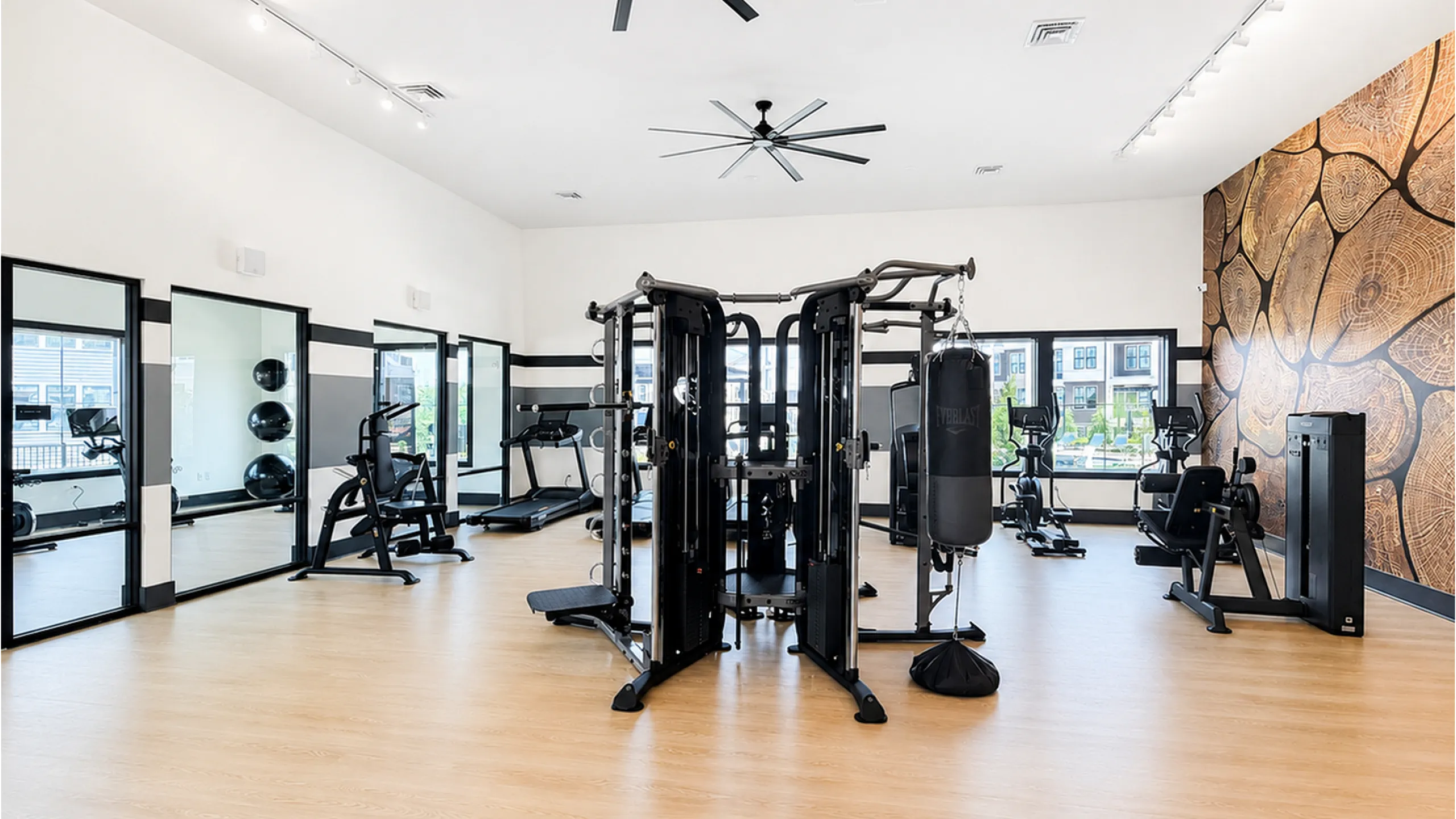 Modern fitness center with state-of-the-art equipment, mirrored walls, and stylish decor for an invigorating workout experience.