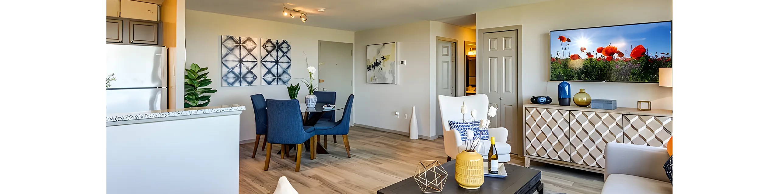 Bright open-concept living and dining area featuring elegant decor, modern furniture, and warm lighting, perfect for entertaining in style.