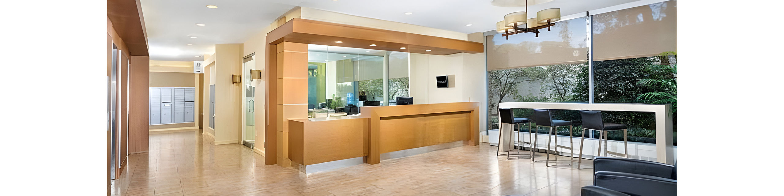 Modern lobby with elegant reception desk, sleek seating, and large windows providing natural light.
