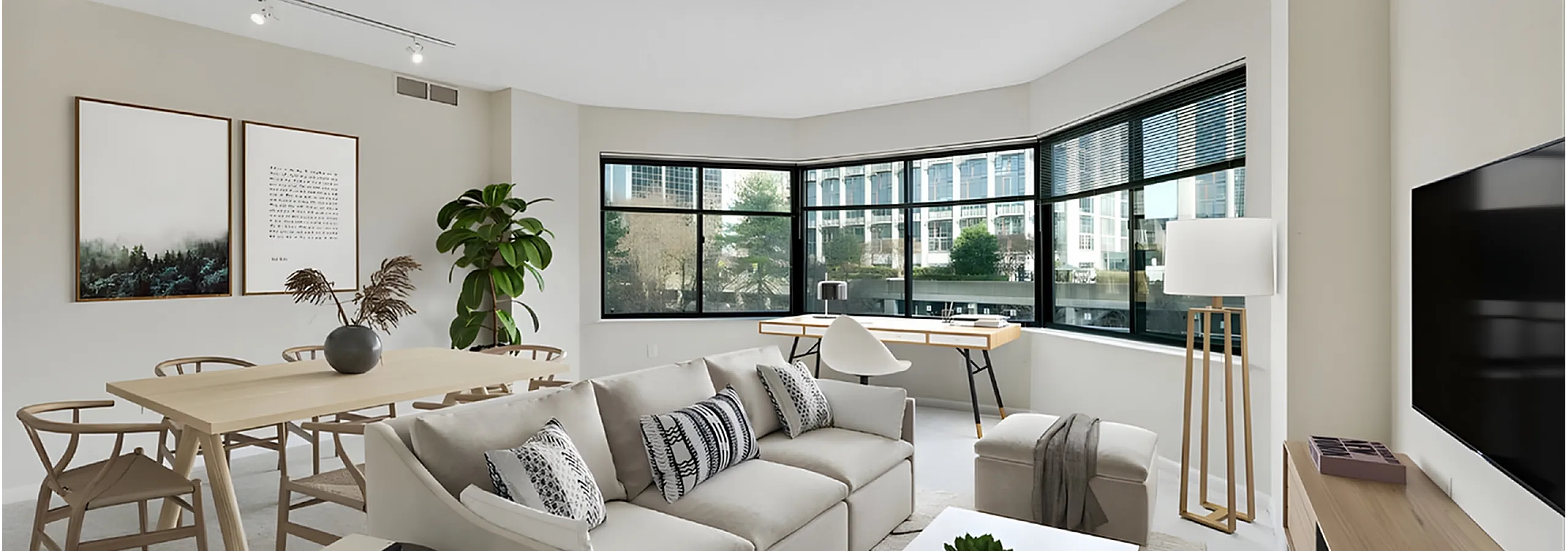 Bright and modern living room with a cozy beige sofa, large windows, and a stylish dining area perfect for entertaining.