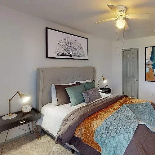 Stylish bedroom with modern decor, featuring a plush bed, artistic wall art, and ambient lighting.